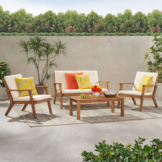 Wooden outdoor furniture set with cream cushions and decorative pillows on patio