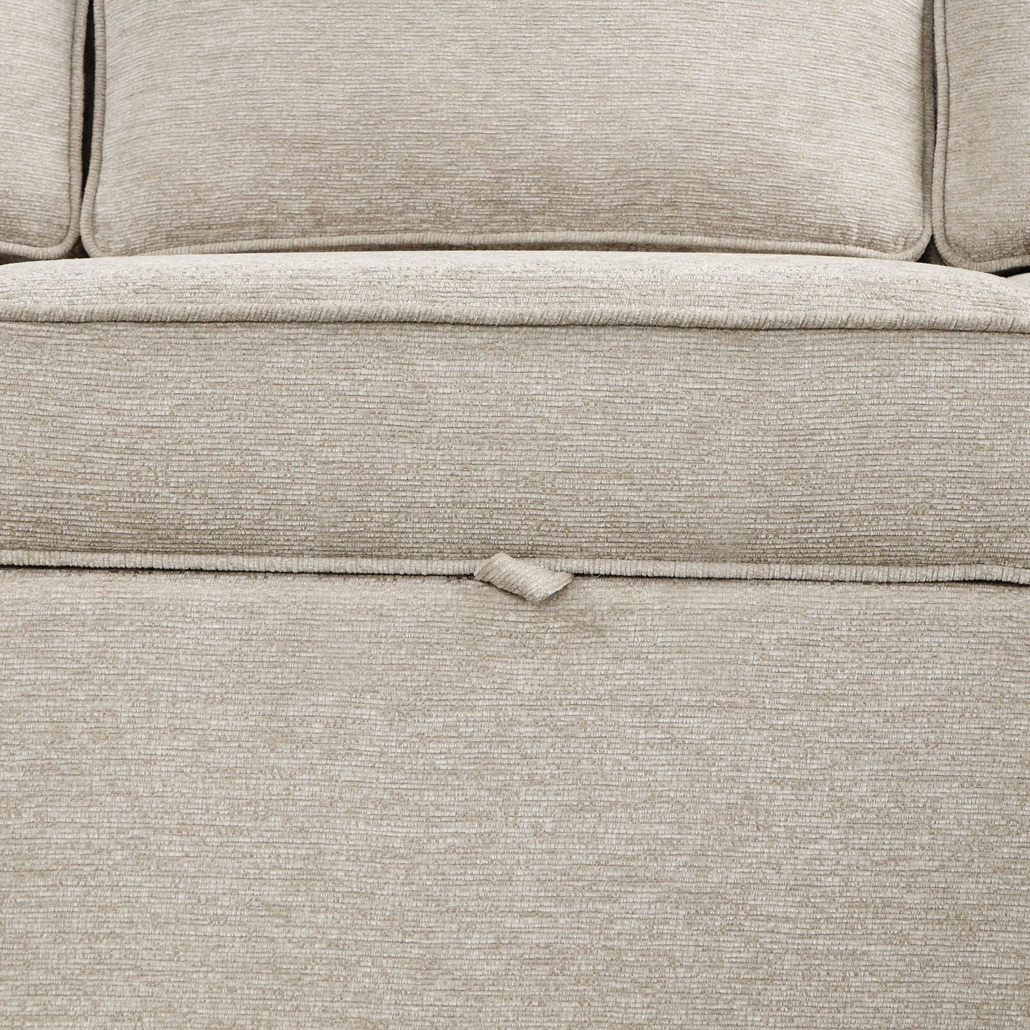Closeup of a beige textured fabric sofa cushion with subtle ribbing highlighting comfort