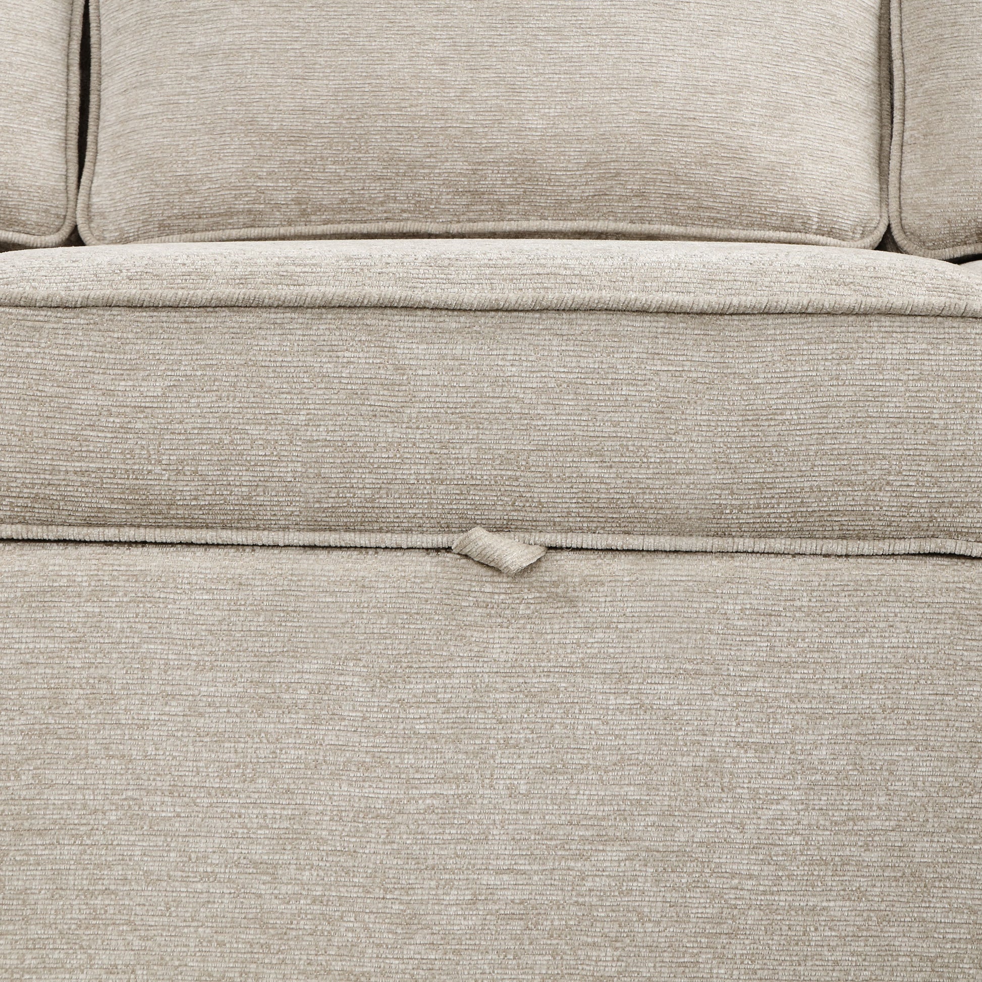 Closeup of a beige textured fabric sofa cushion with subtle ribbing highlighting comfort