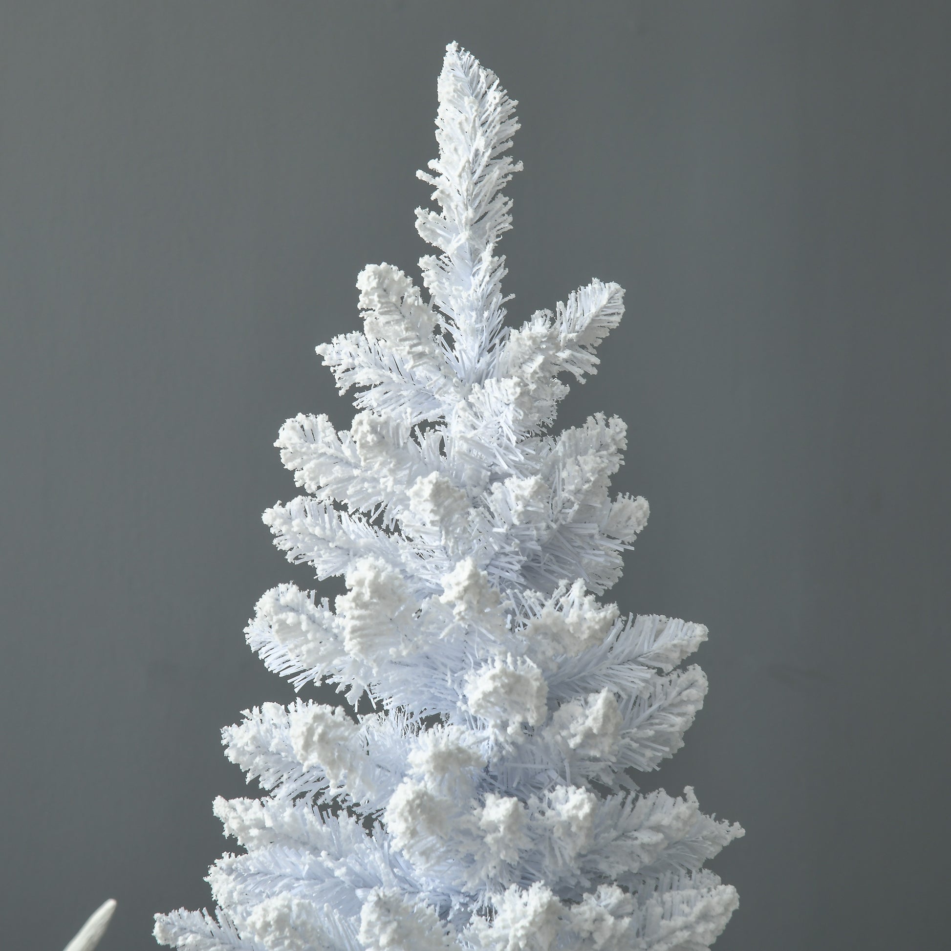 White flocked artificial Christmas tree with snowlike texture