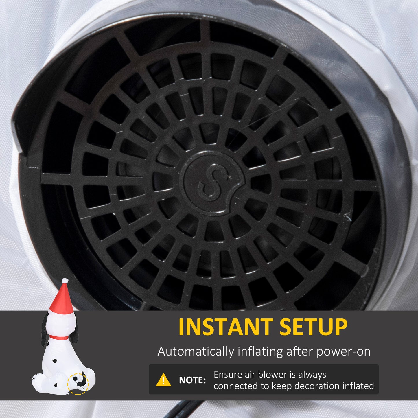 Closeup of a black fan grill with a circular pattern on a white fabric background