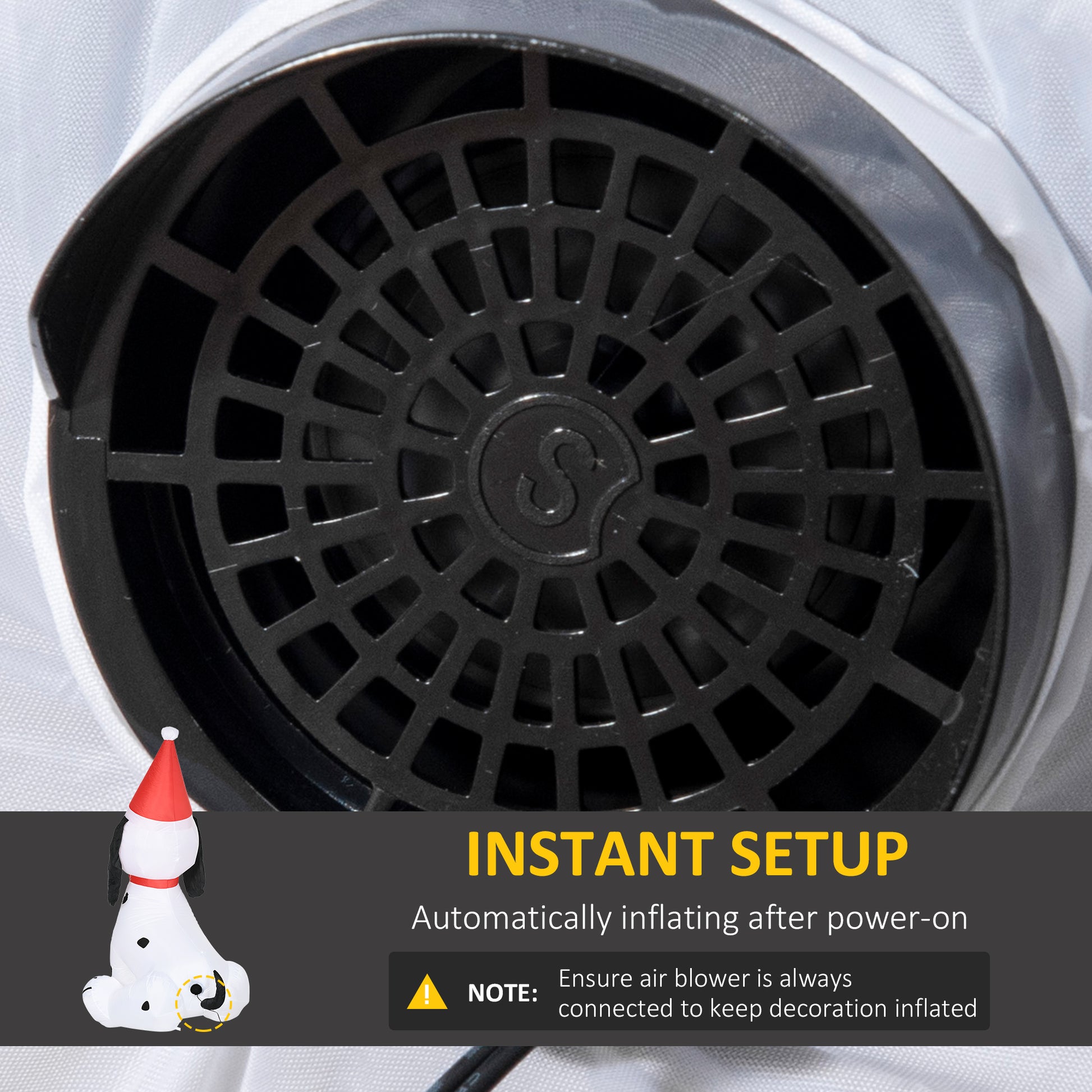 Closeup of a black fan grill with a circular pattern on a white fabric background
