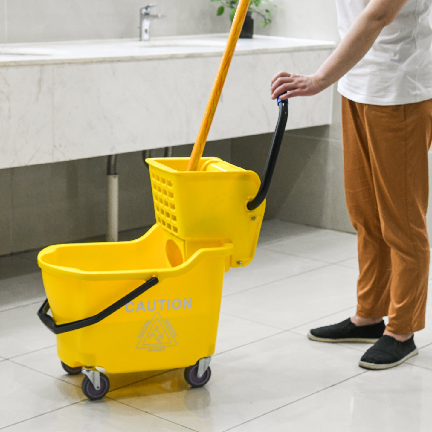Yellow janitorial mop bucket with wringer and caution sign ideal for commercial cleaning