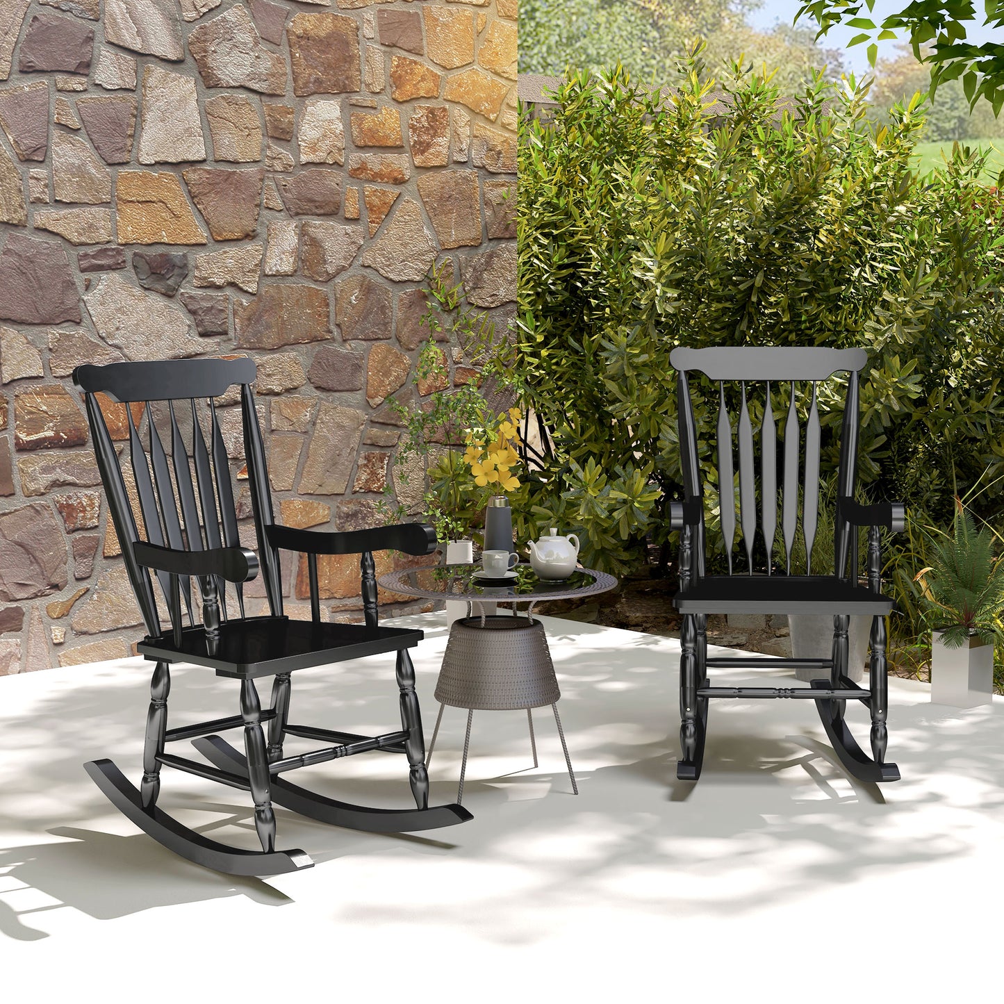 Black wooden rocking chair with spindle back and armrests on patio