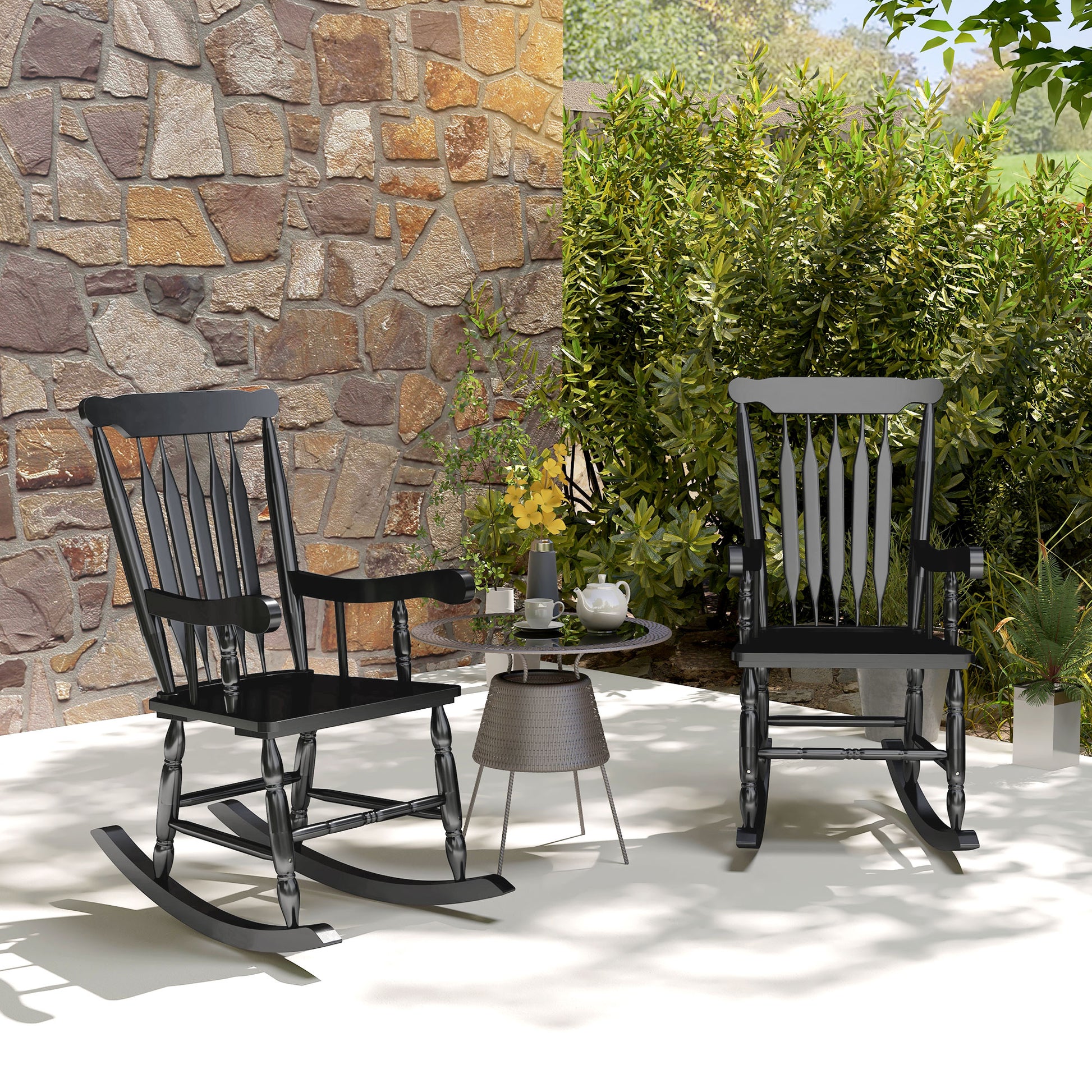Black wooden rocking chair with spindle back and armrests on patio