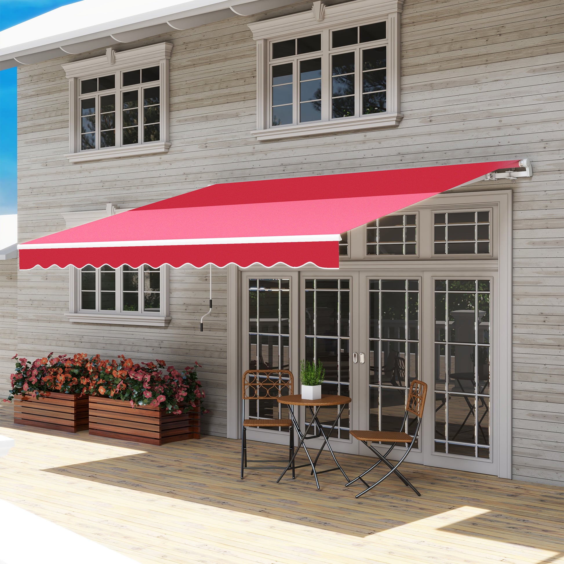 Red retractable patio awning with scalloped edge providing shade for outdoor seating