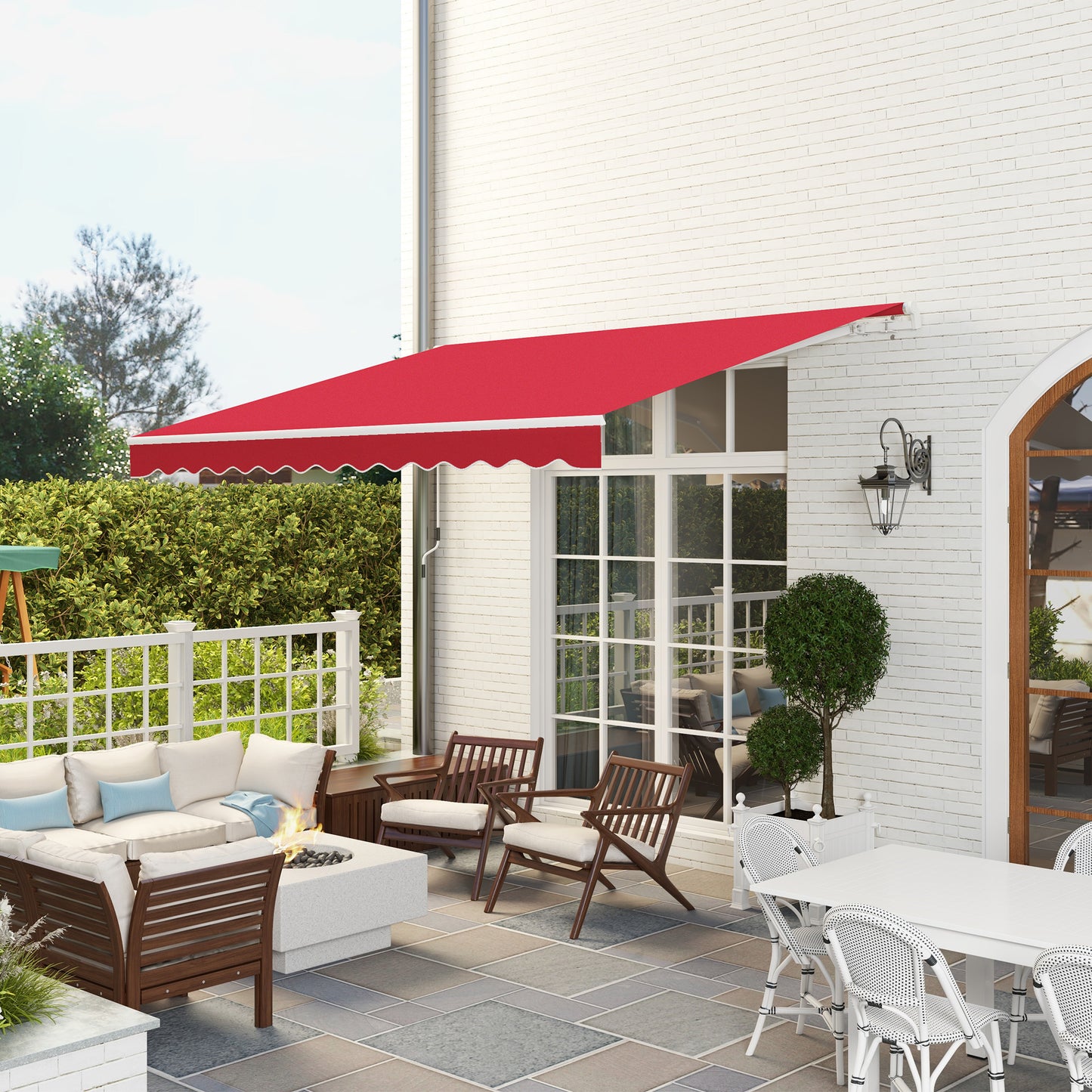 Retractable red patio awning providing shade for outdoor seating area with fire pit