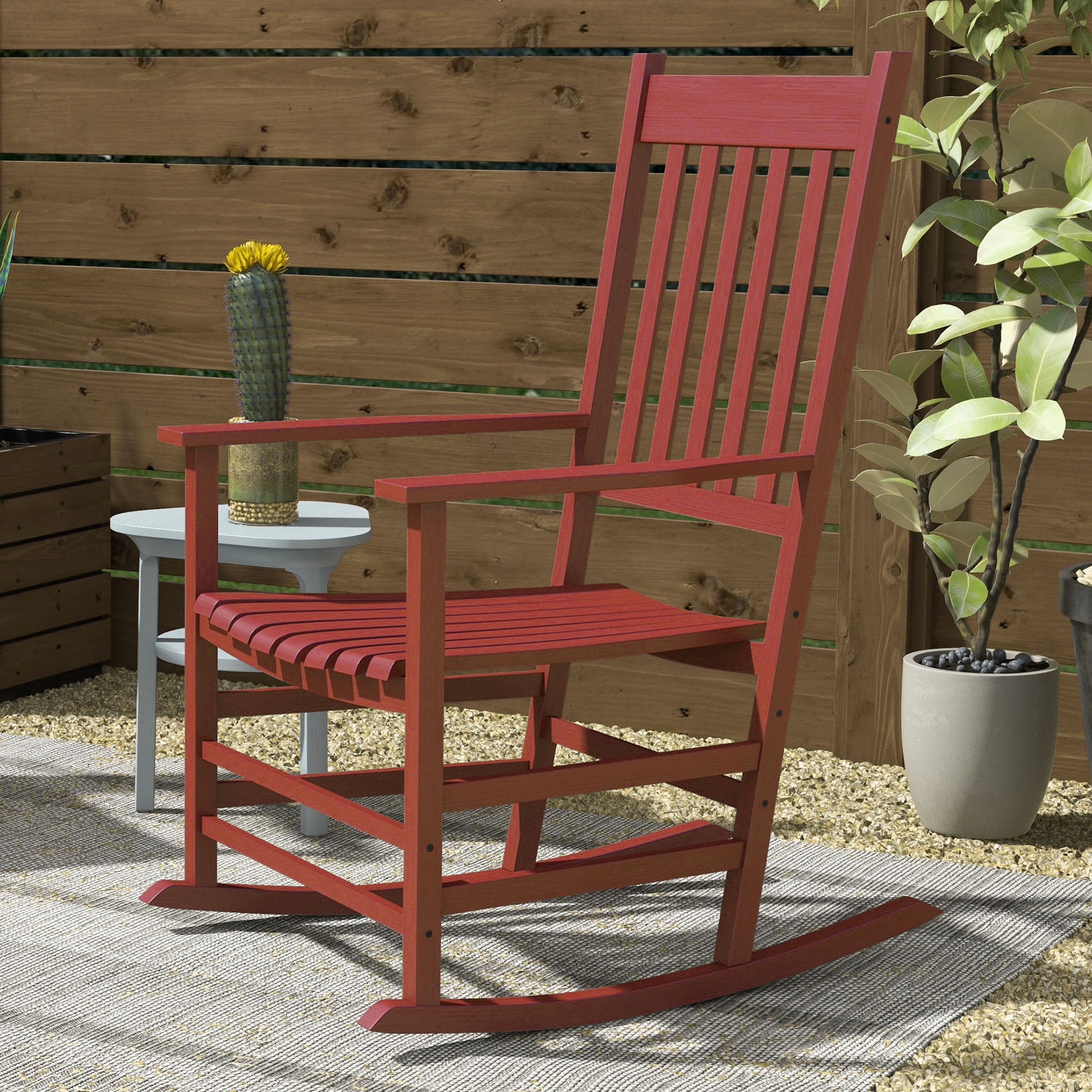 Red wooden outdoor rocking chair with slatted seat and back