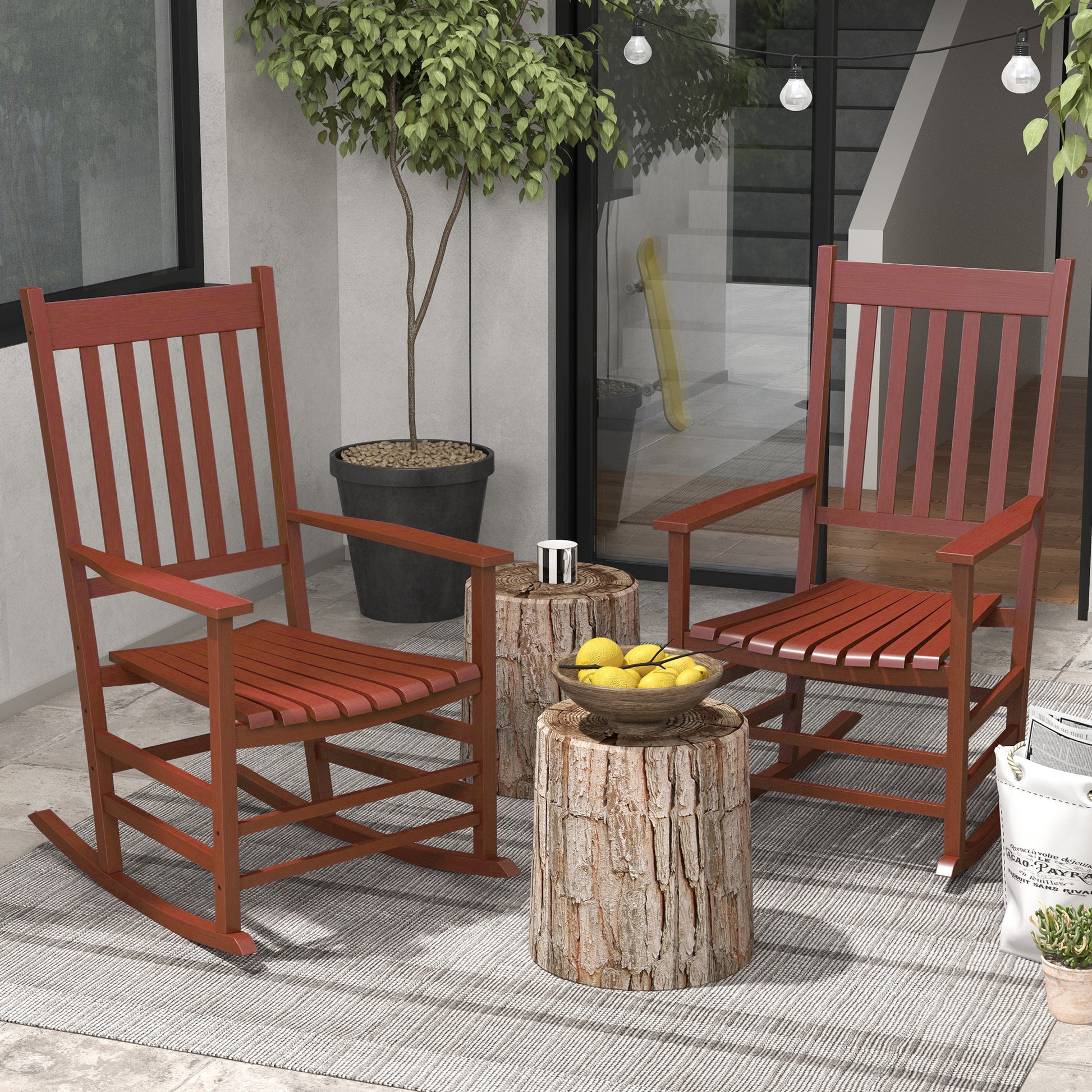 Two classic red wooden rocking chairs on an outdoor patio perfect for a relaxed porch