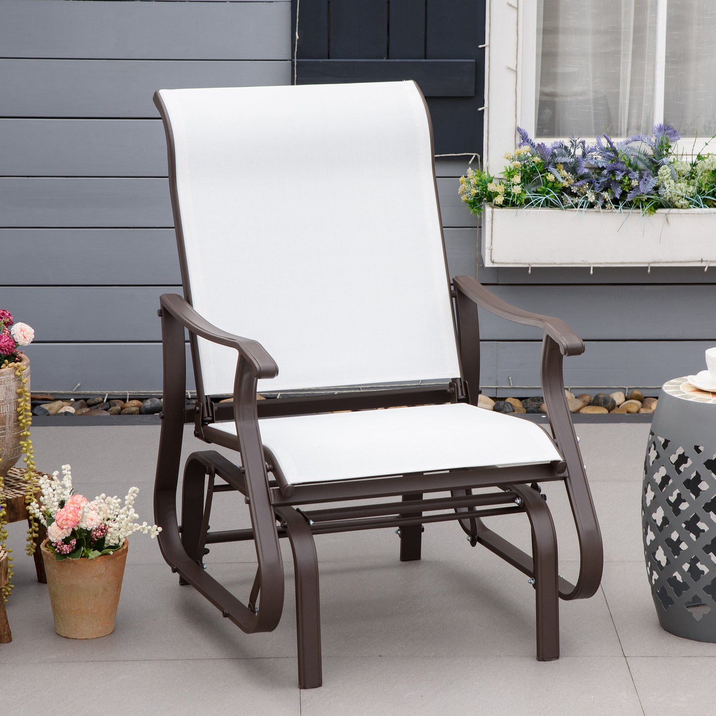 Comfortable white fabric patio glider chair with dark brown metal frame perfect for outdoor relaxation