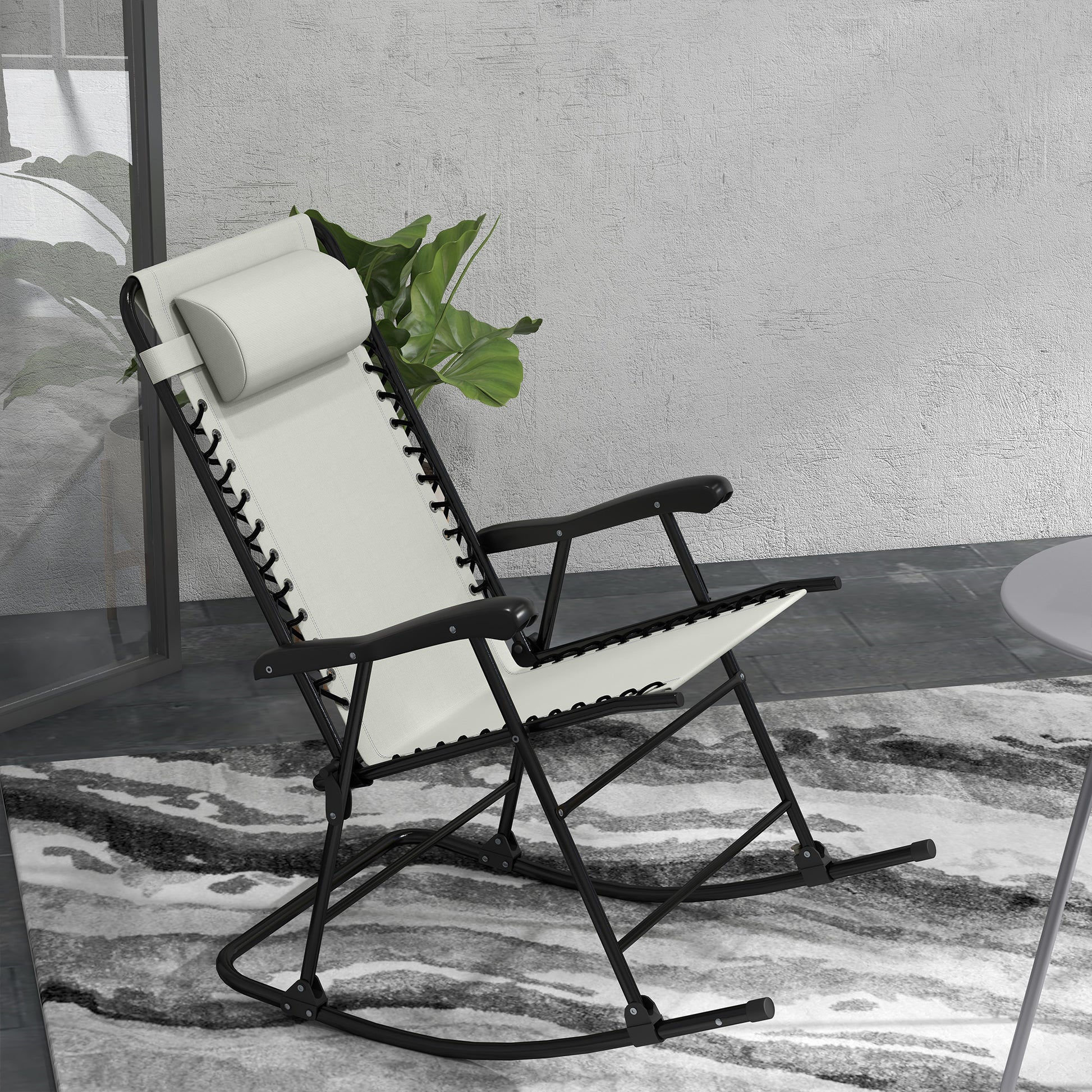 Offwhite zero gravity chair with black frame and adjustable headrest ideal for patio relaxation