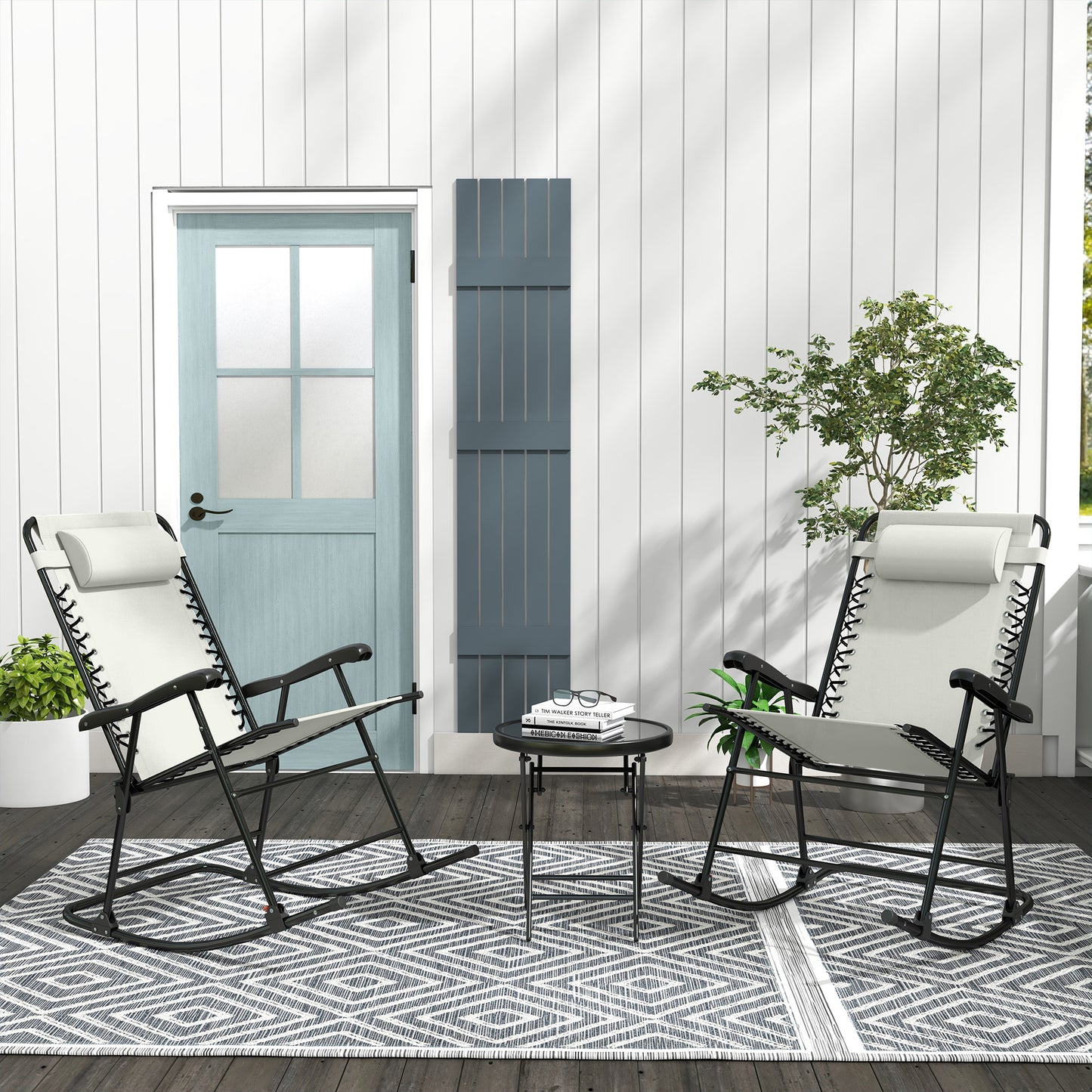 Two white zero gravity chairs with black frames on a patio rug