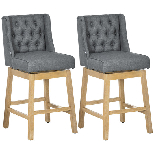 Two grey upholstered swivel bar stools with tufted backs and light wood legs