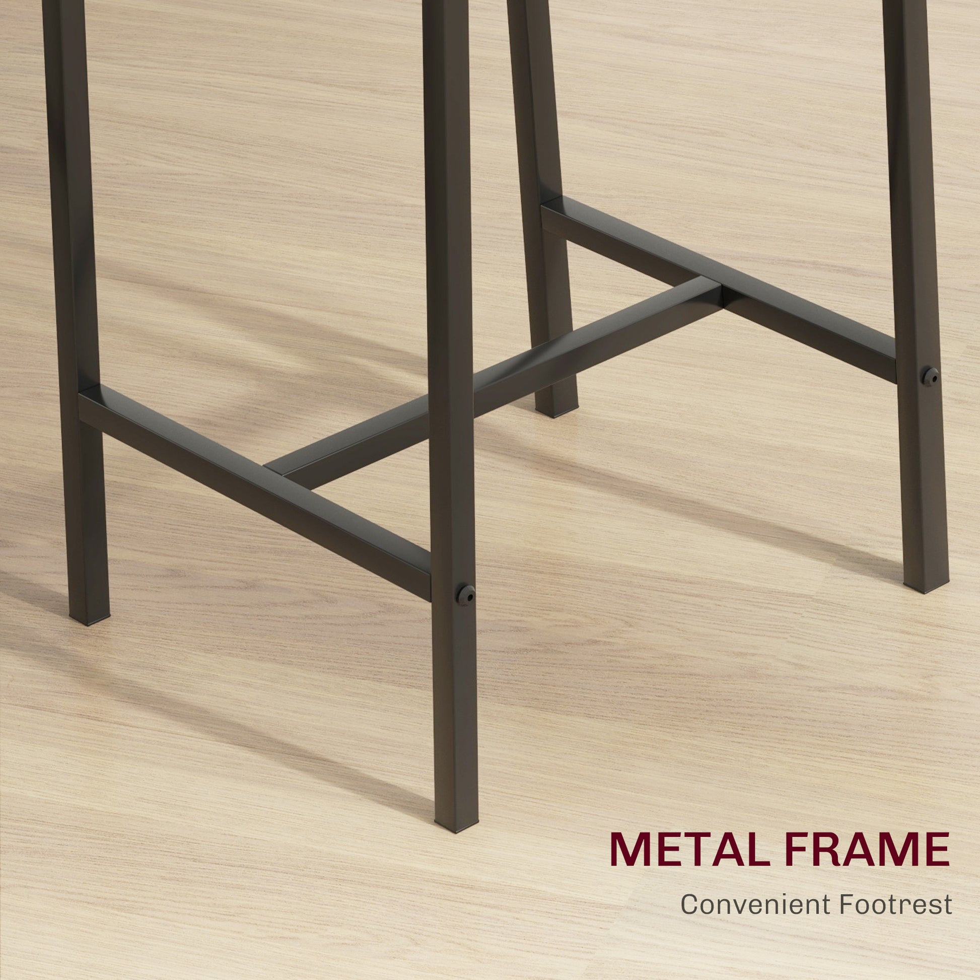 Dark gray metal frame and footrest detail on a light wood floor
