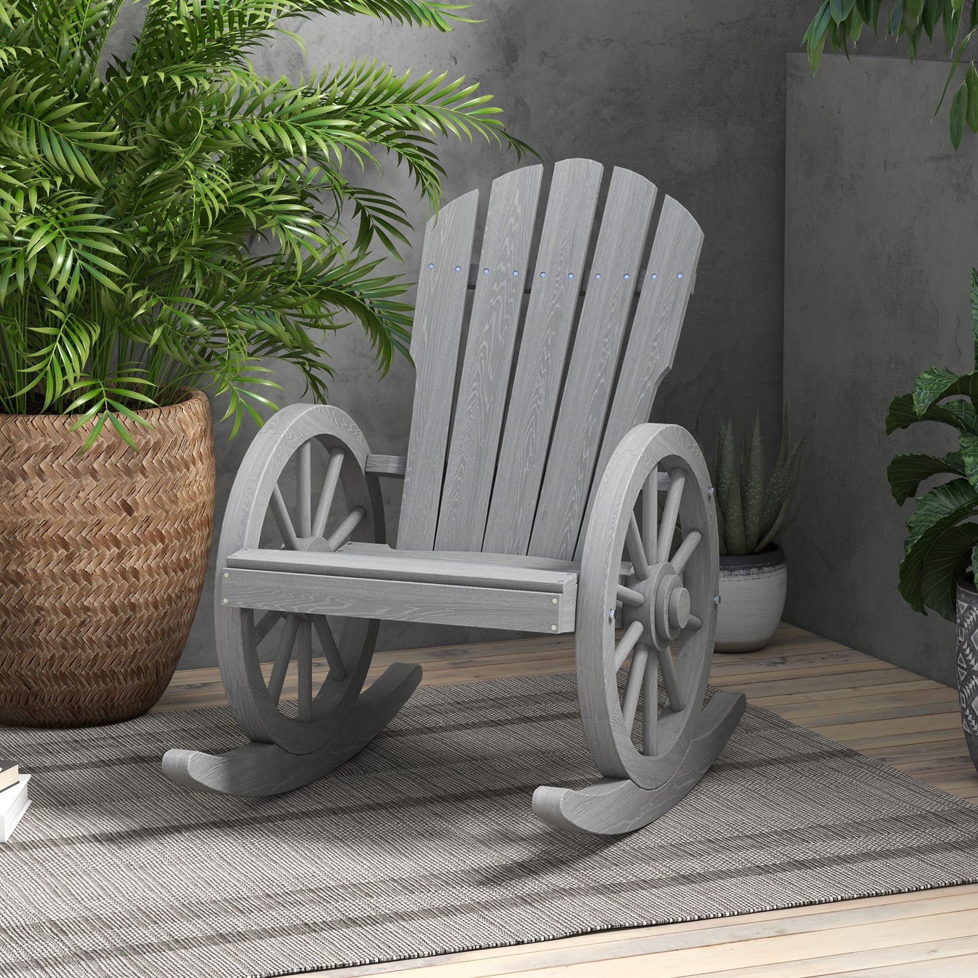 Gray wooden rocking chair with wagon wheel arms and arched backrest on an outdoor patio