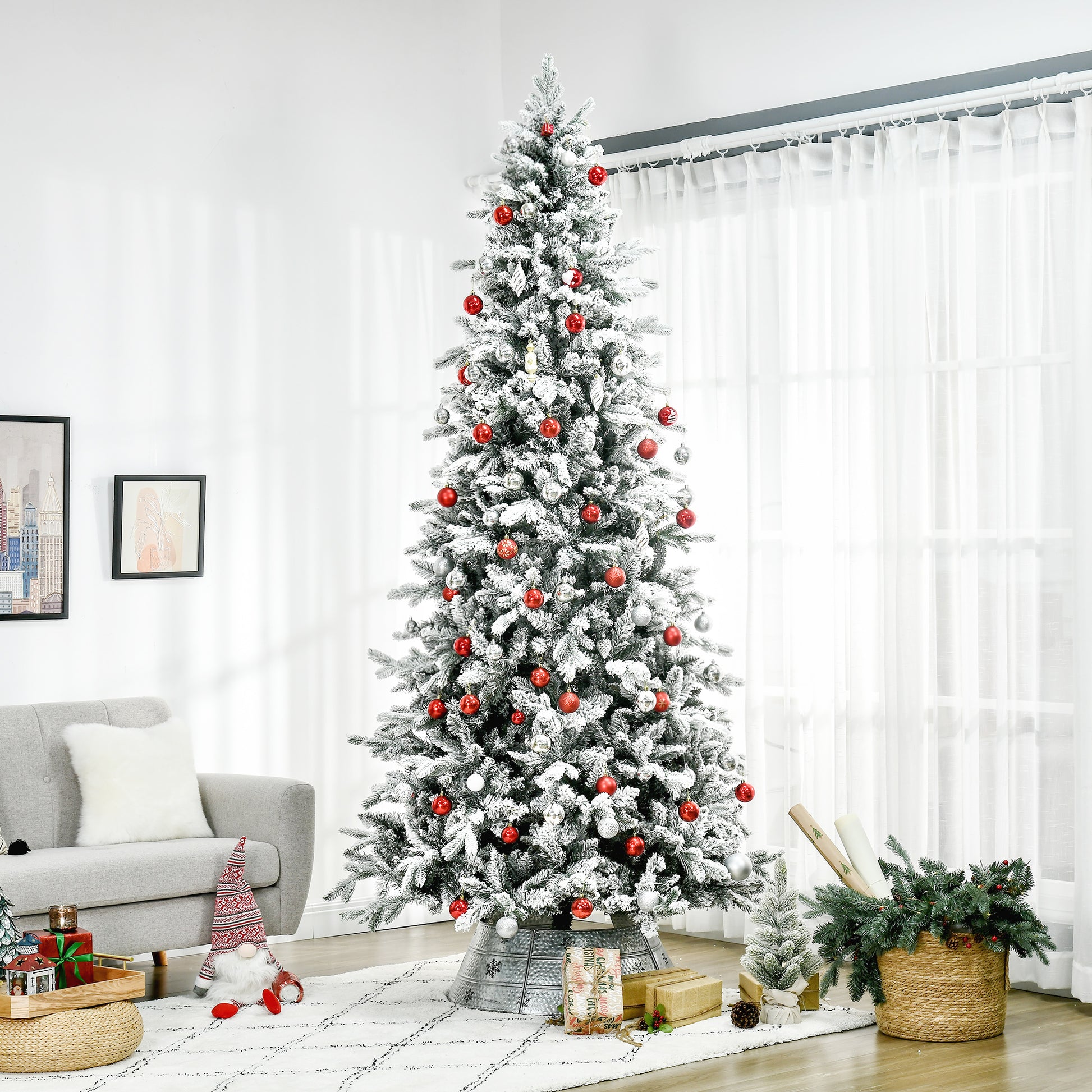 Tall flocked artificial Christmas tree with red and silver ornaments