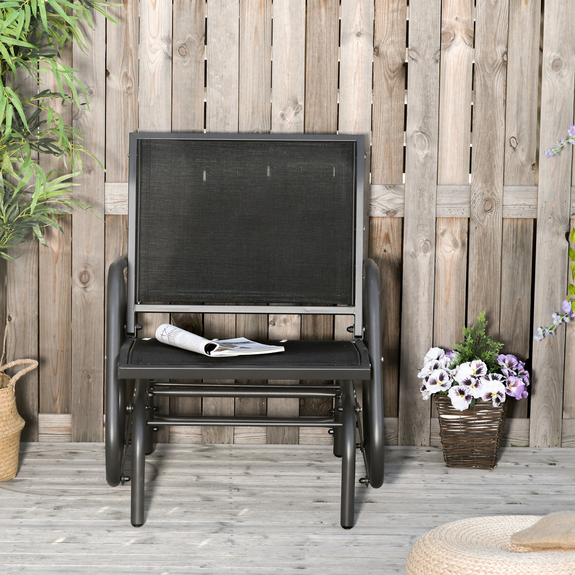 Gray metal outdoor glider chair with black mesh seat and back perfect for patio relaxation