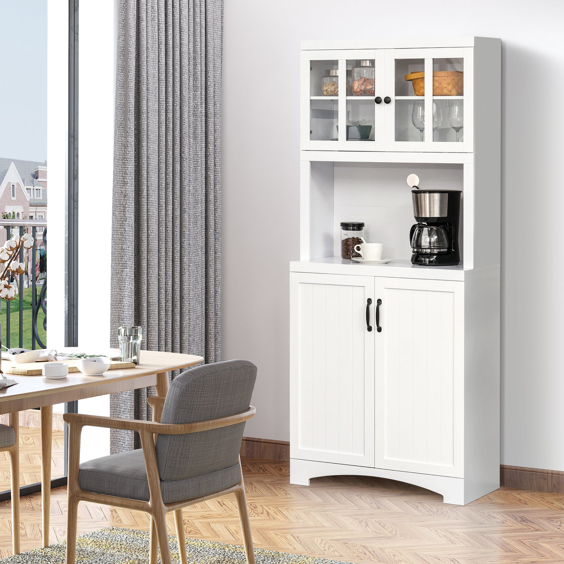 White kitchen hutch with glass doors displaying jars and glasses and a coffee maker