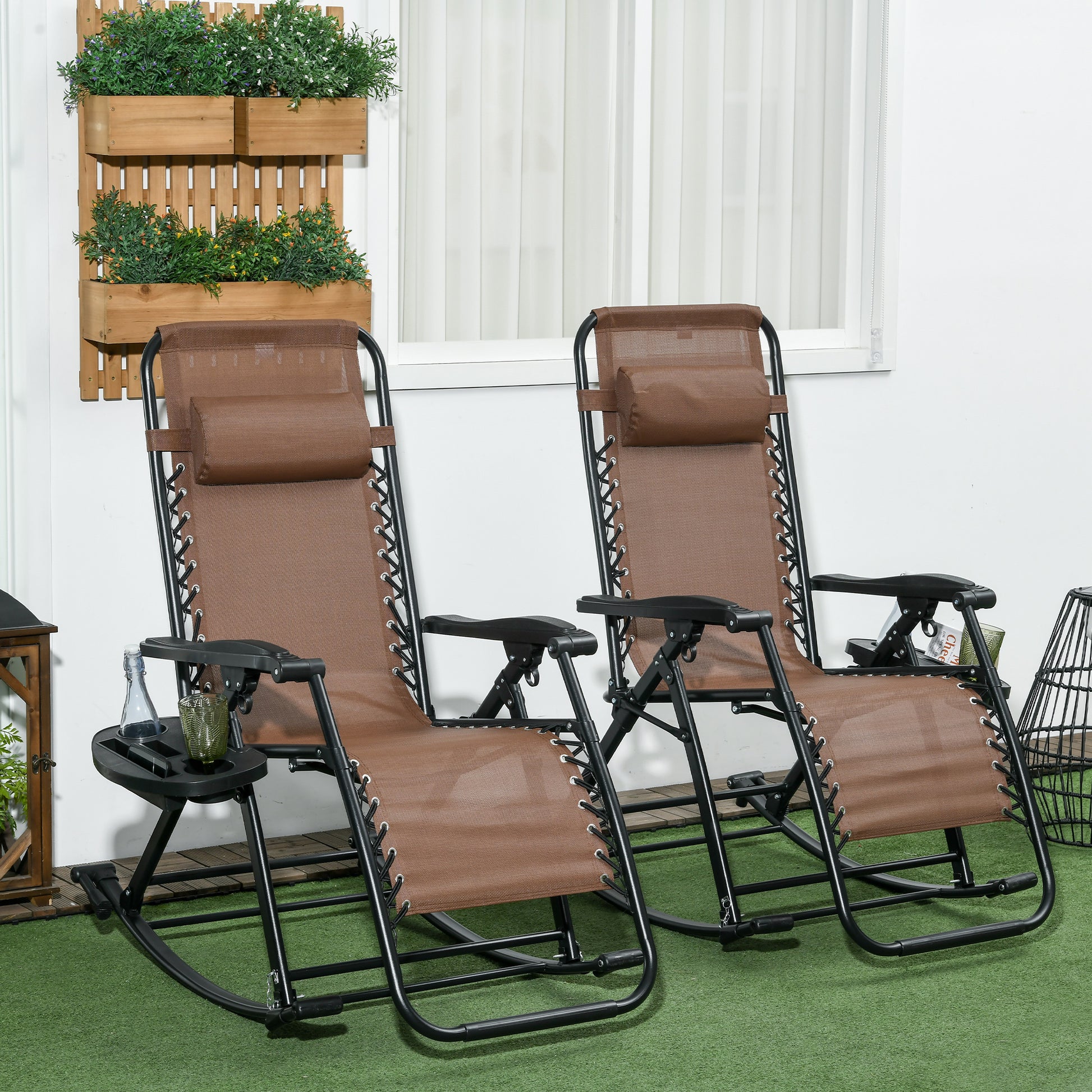 Two brown zero gravity chairs with black frames and side tables for patio relaxation