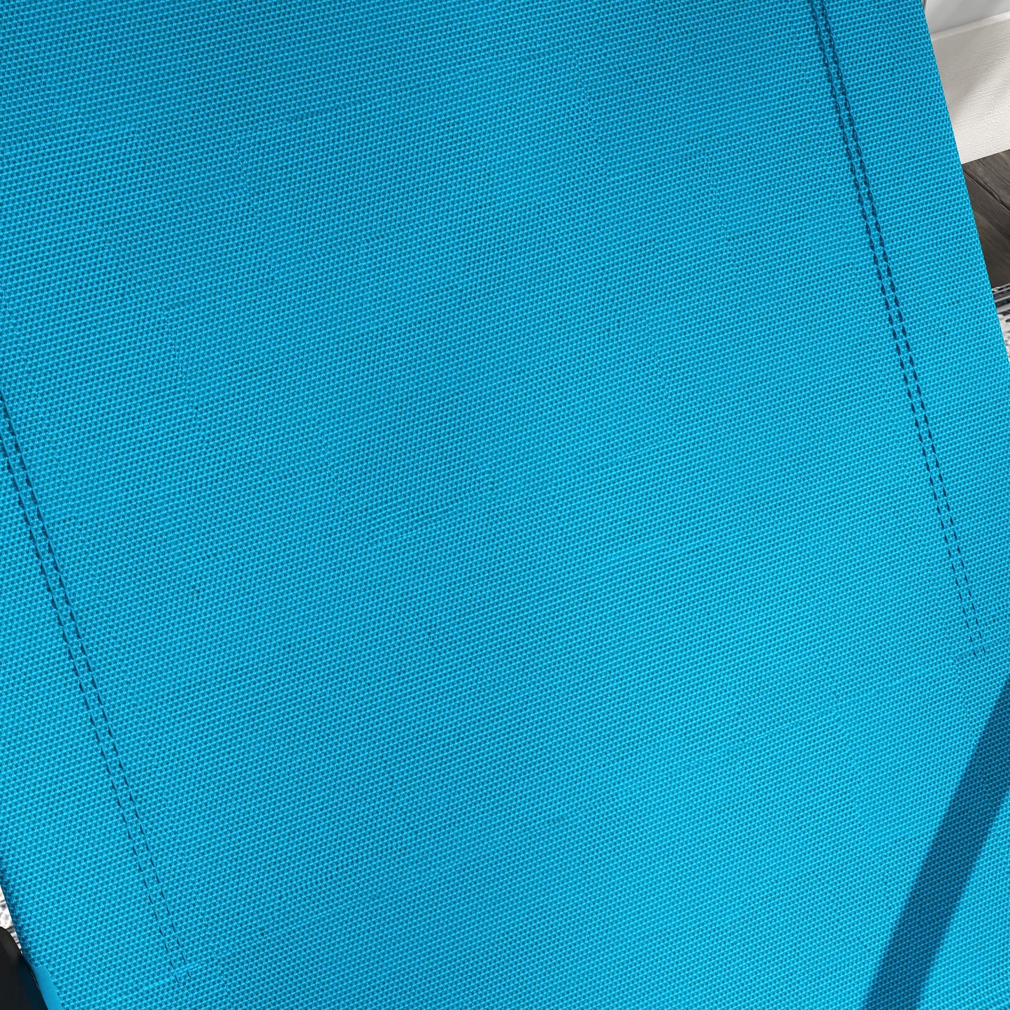 Closeup of a bright blue woven fabric ideal for outdoor furniture