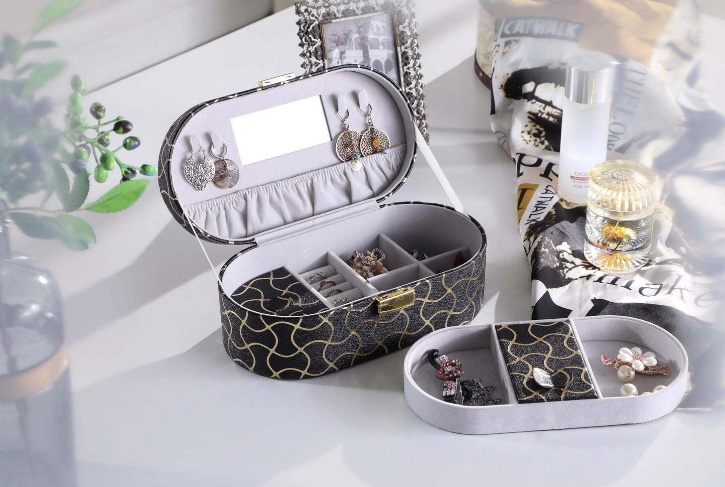 Oval black jewelry box with gold pattern