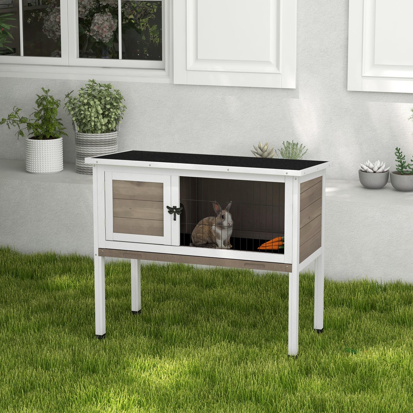 Elevated wooden rabbit hutch with wire mesh enclosure and carrot outdoor pet housing