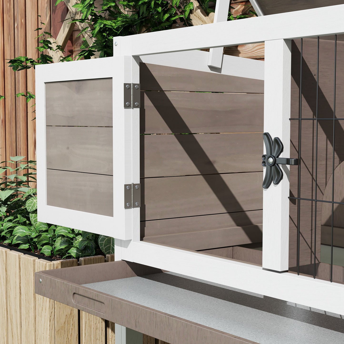 White and brown wood rabbit hutch with a wire mesh door and dragonfly latch