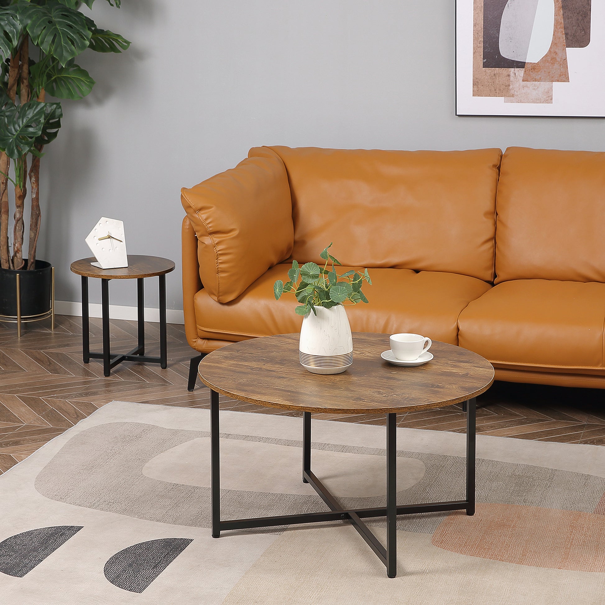 Round wood coffee table with black metal base and modern design for living room