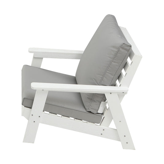 White Adirondack chair with plush grey cushions for outdoor relaxation