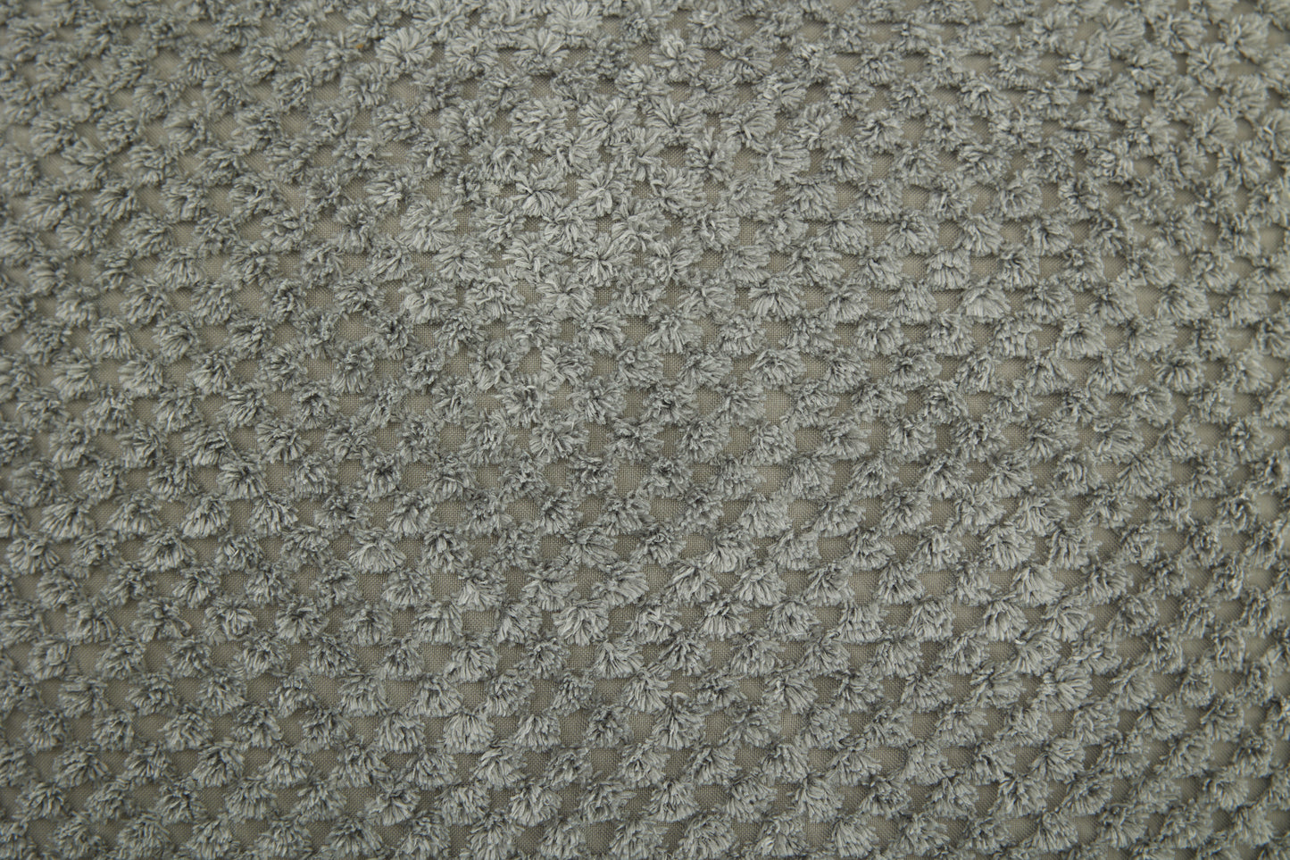 Closeup of textured gray chenille fabric showcasing a dense looped pile Ideal for upholstery
