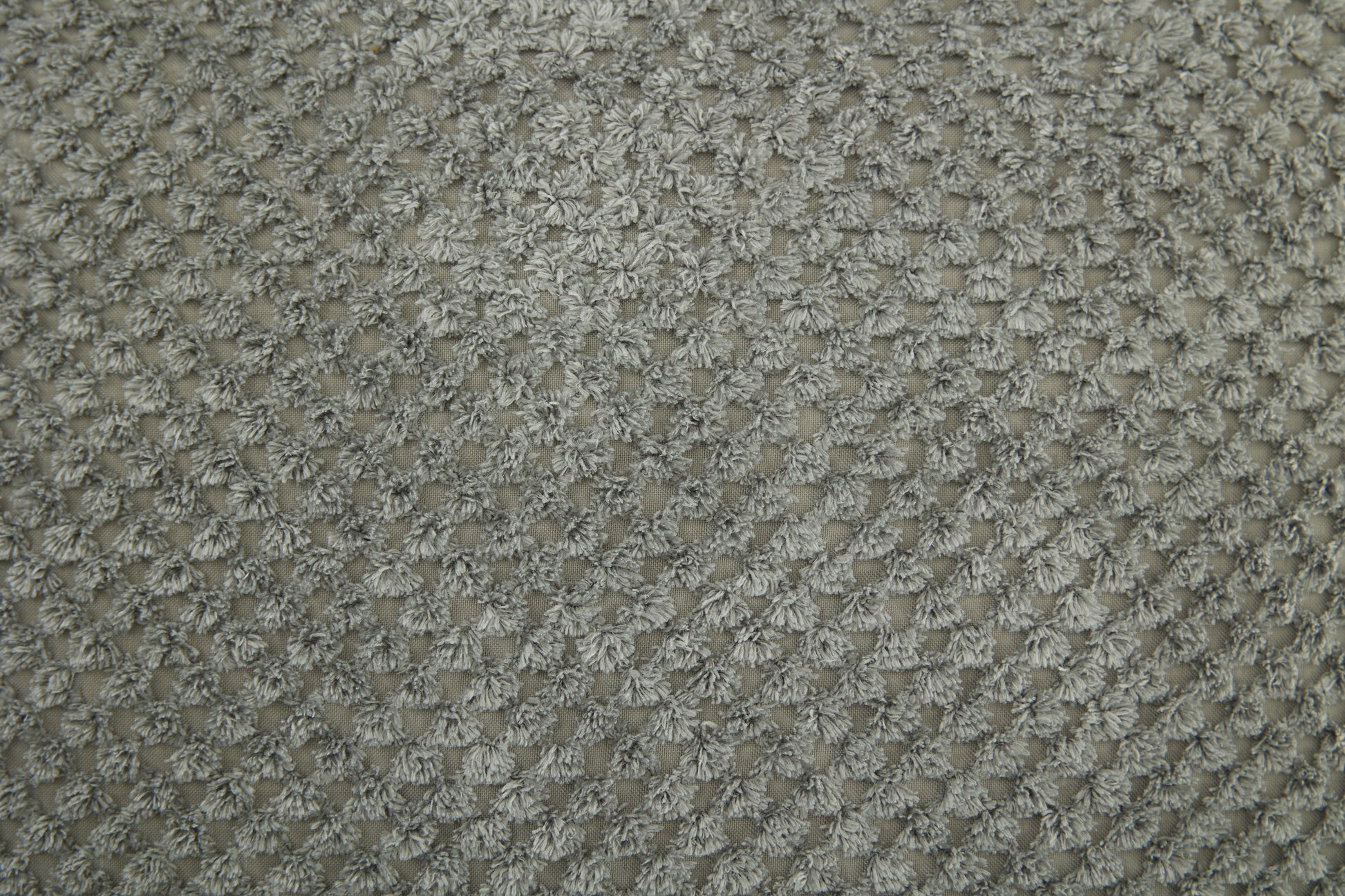 Closeup of textured gray chenille fabric showcasing a dense looped pile Ideal for upholstery