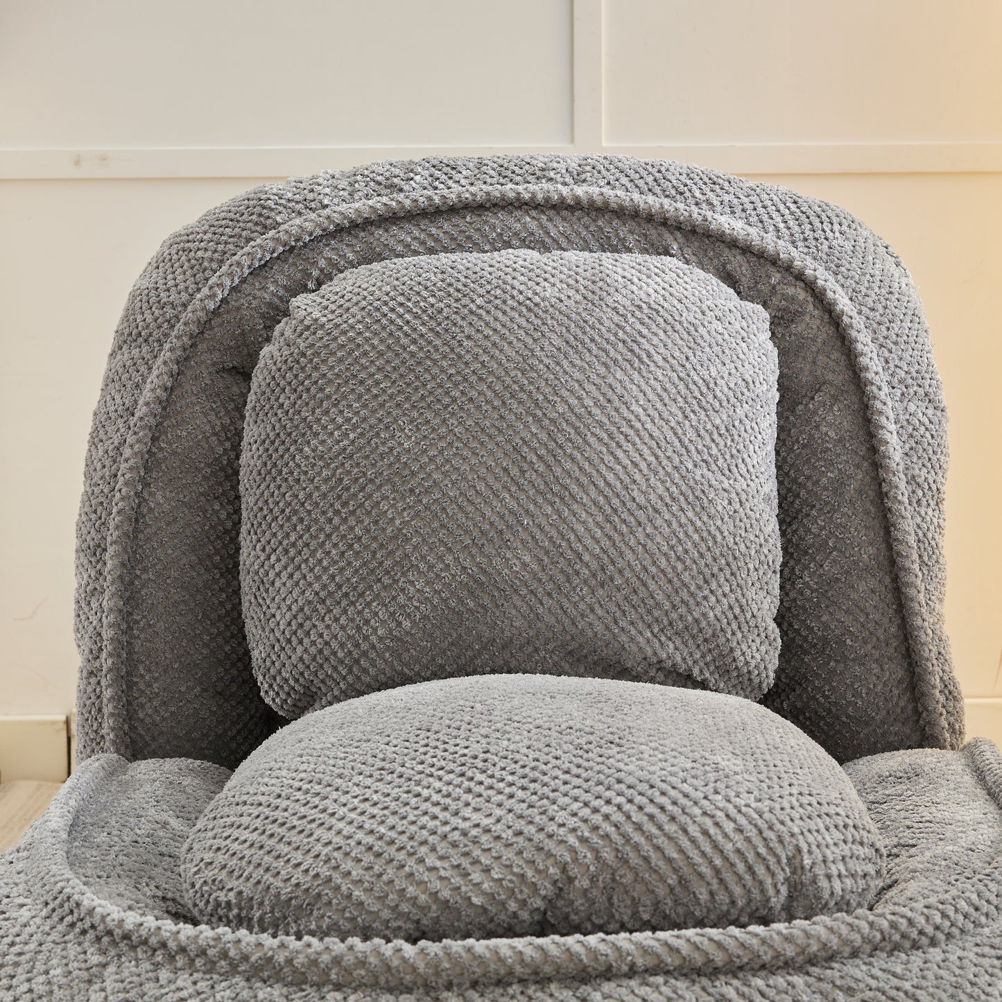 Plush grey bean bag chair with textured fabric ideal for cozy lounging