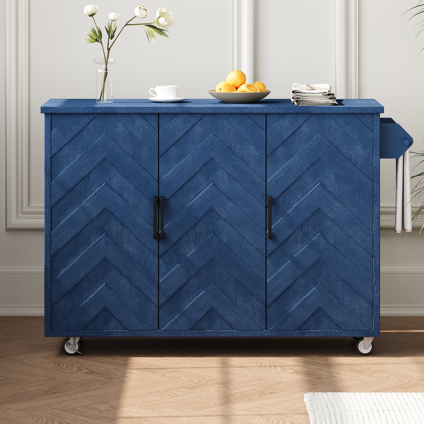 Navy blue cabinet with chevron pattern doors and black handles on wheels