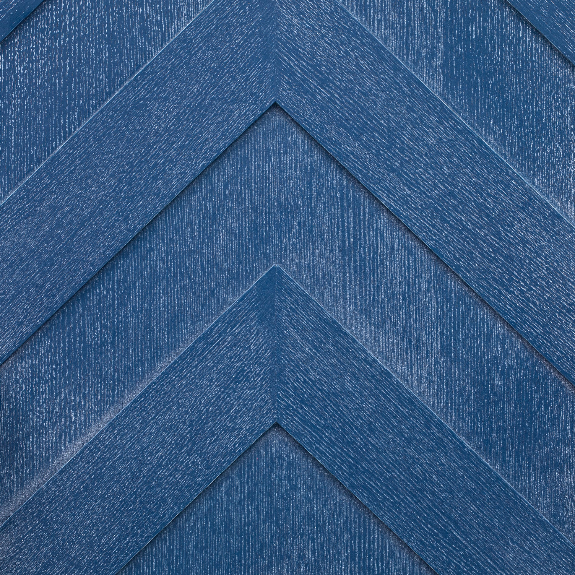 Deep blue wood paneling with a chevron pattern
