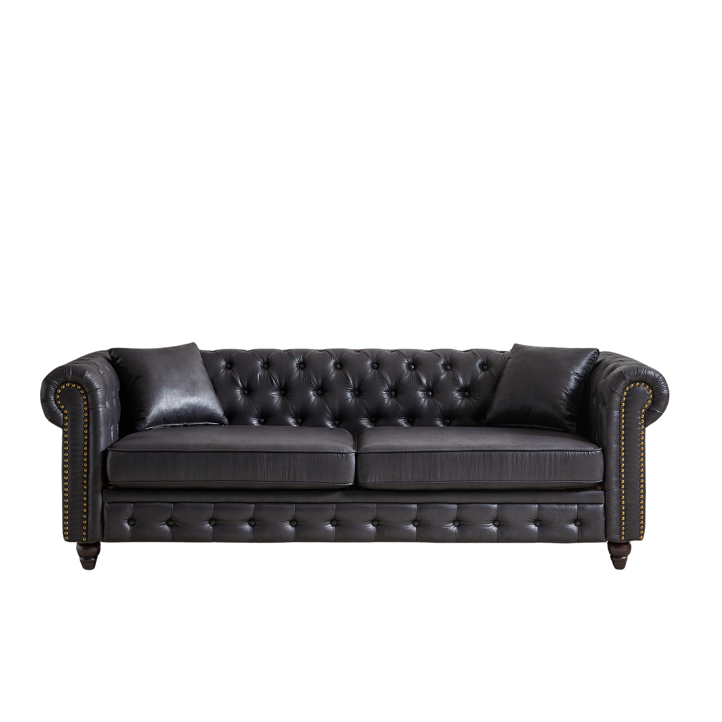 Black tufted faux leather chesterfield sofa with brass nailhead trim and two accent pillows