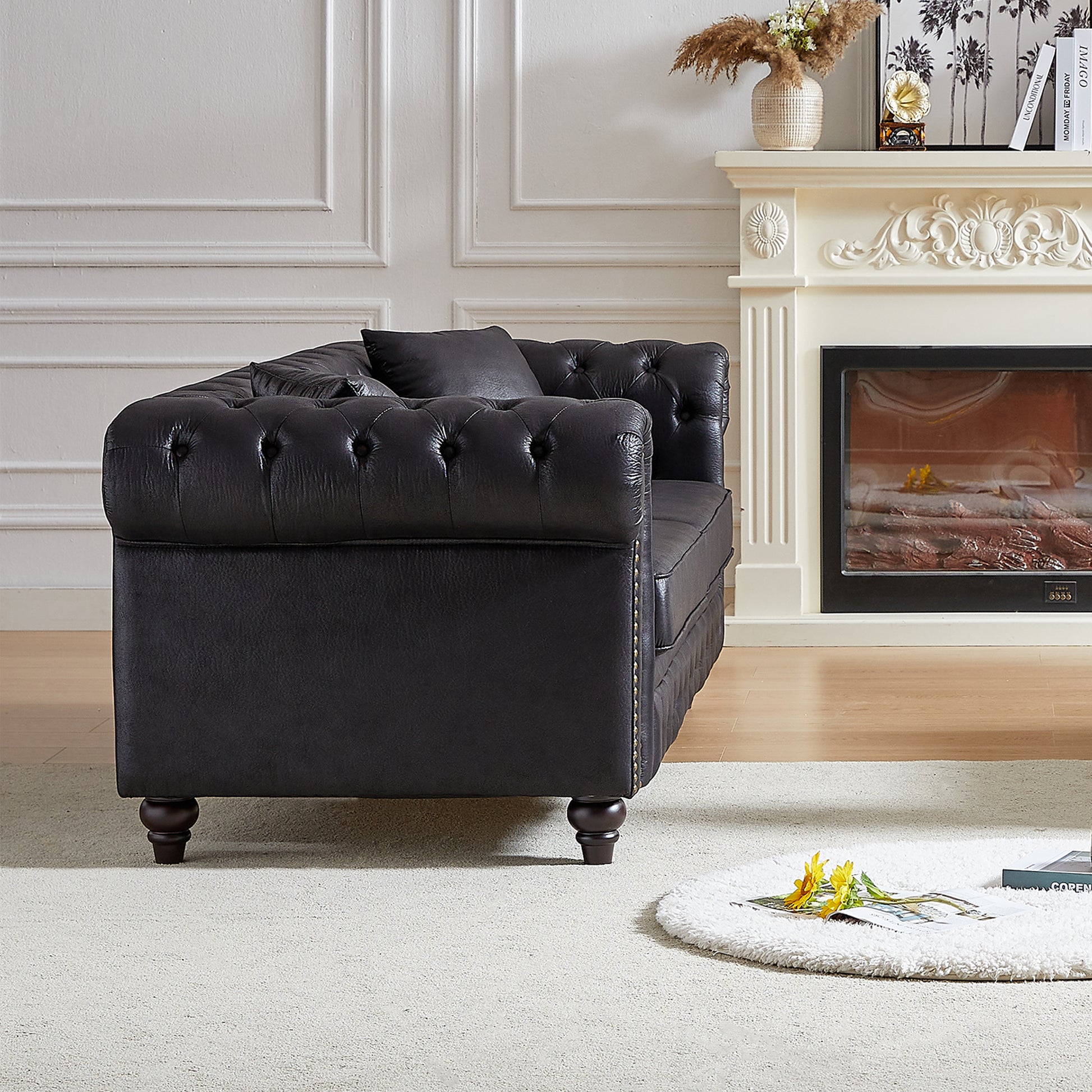 Dark brown tufted leather chesterfield sofa with plush cushions and ornate wooden legs