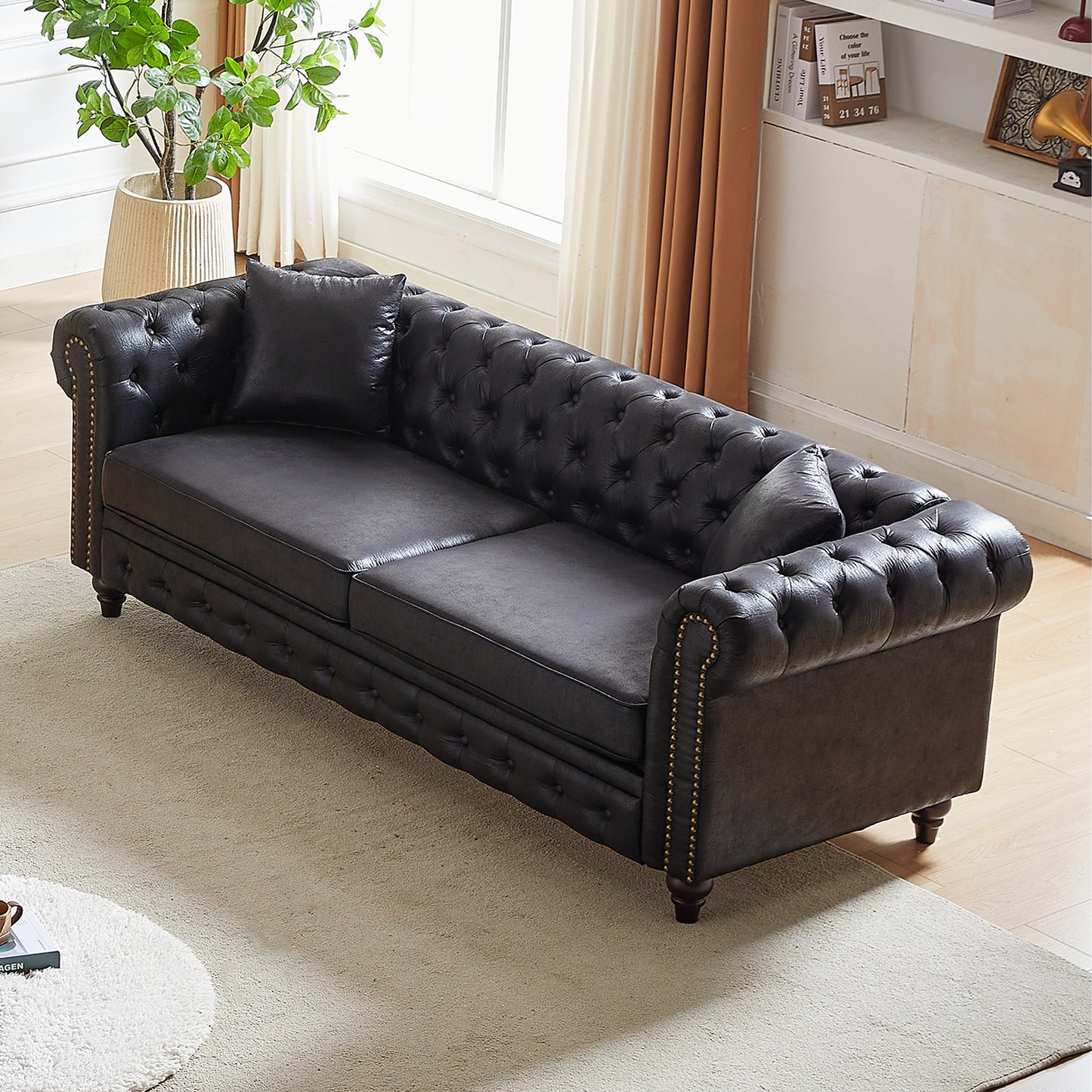Deep brown leather tufted sofa with nailhead trim and plush cushions