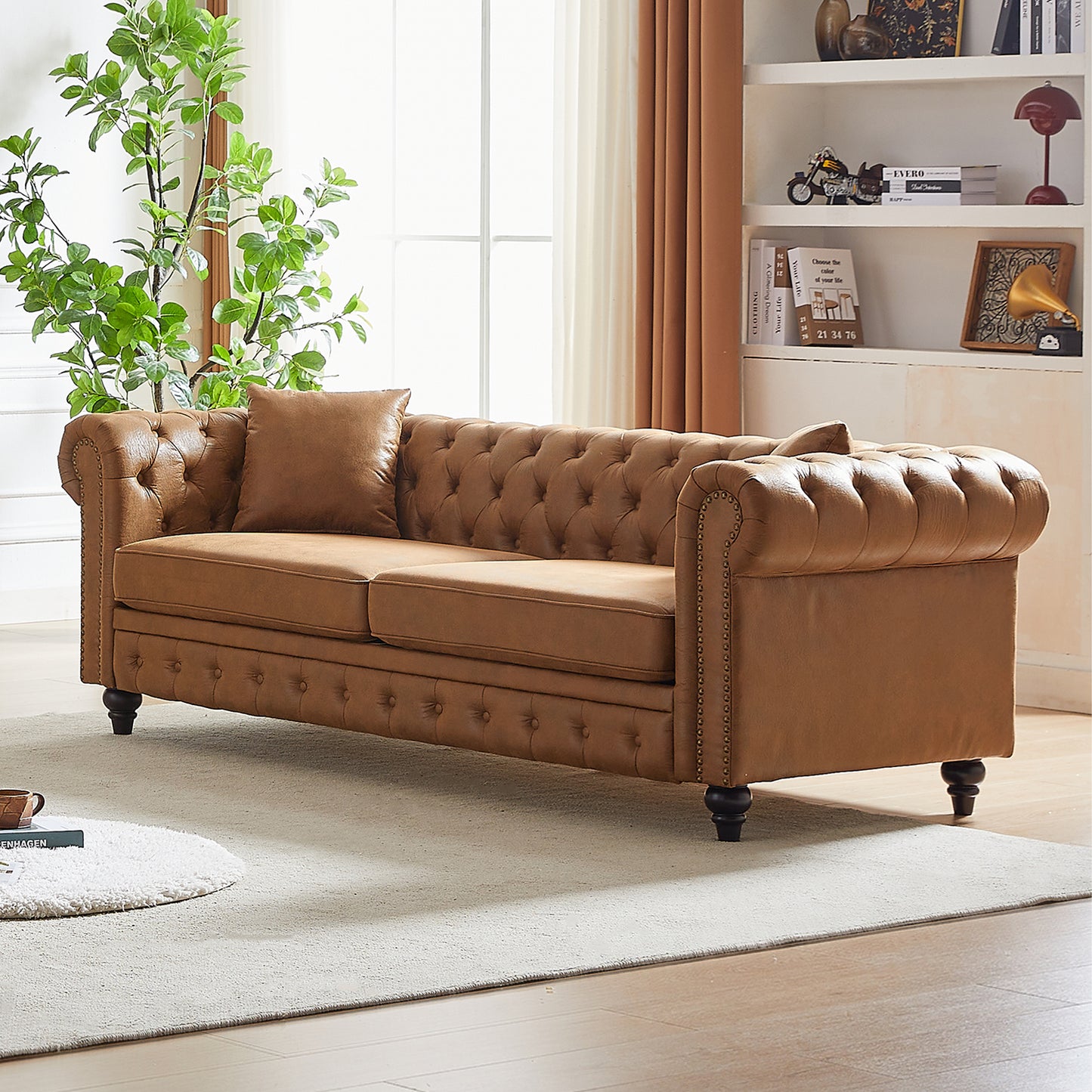 Brown leather tufted Chesterfield sofa with nailhead trim and dark wooden legs perfect for living rooms