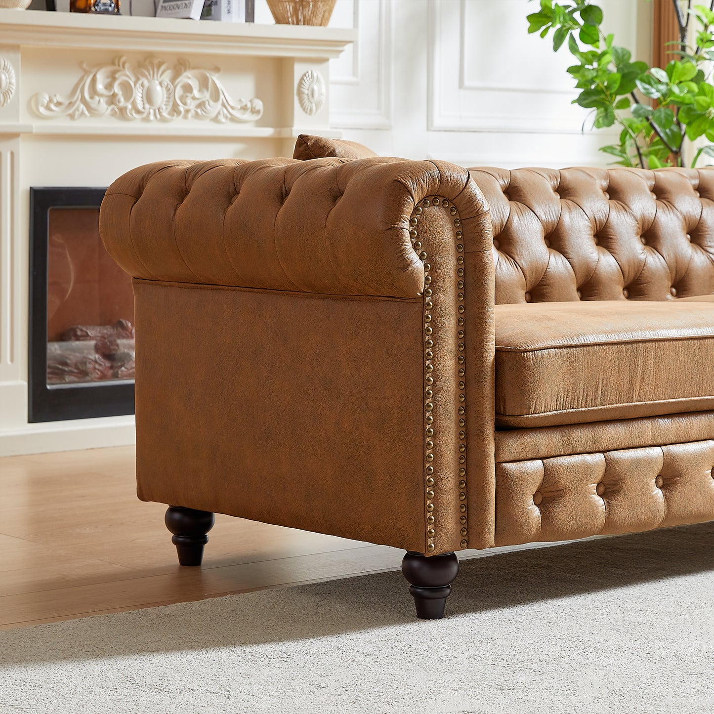 Brown leather chesterfield sofa with button tufting and nailhead trim