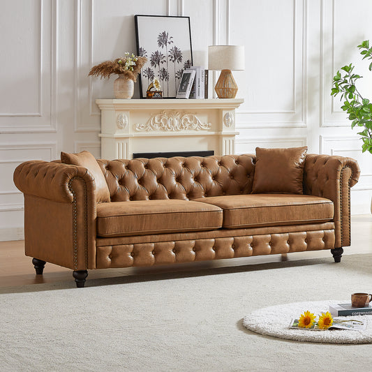 Brown leather chesterfield sofa with button tufting and nailhead trim
