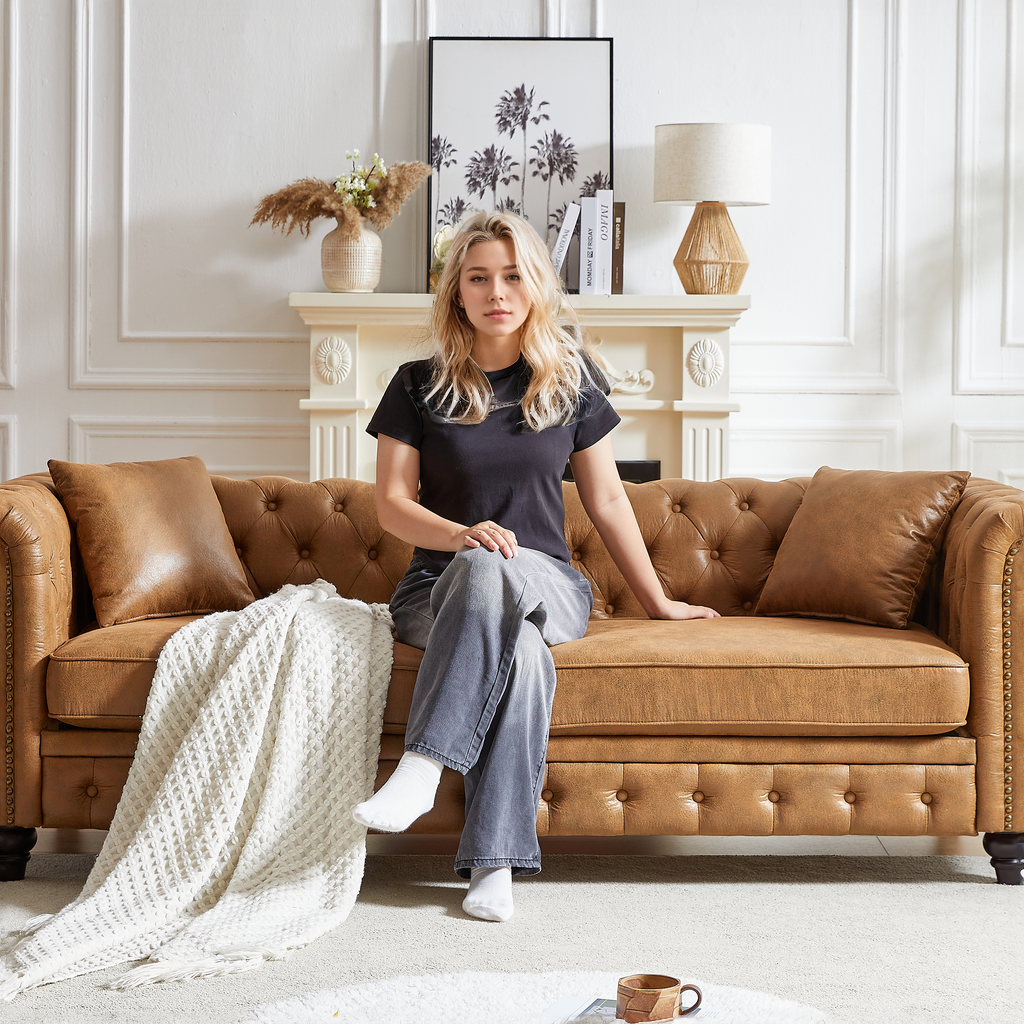 Tan leather chesterfield sofa with tufted details and nailhead trim a luxurious living room accent