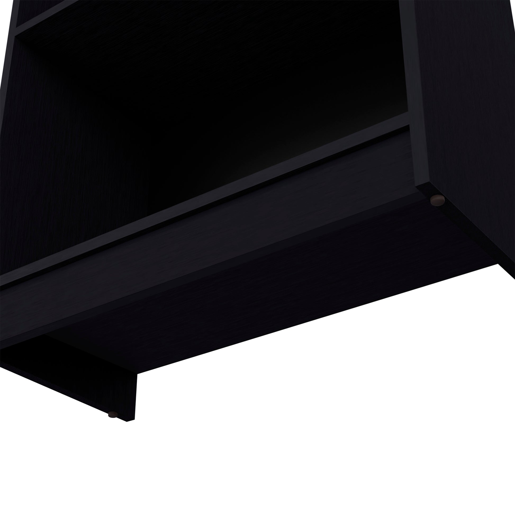 Closeup of a black minimalist bookshelf with visible wood grain texture