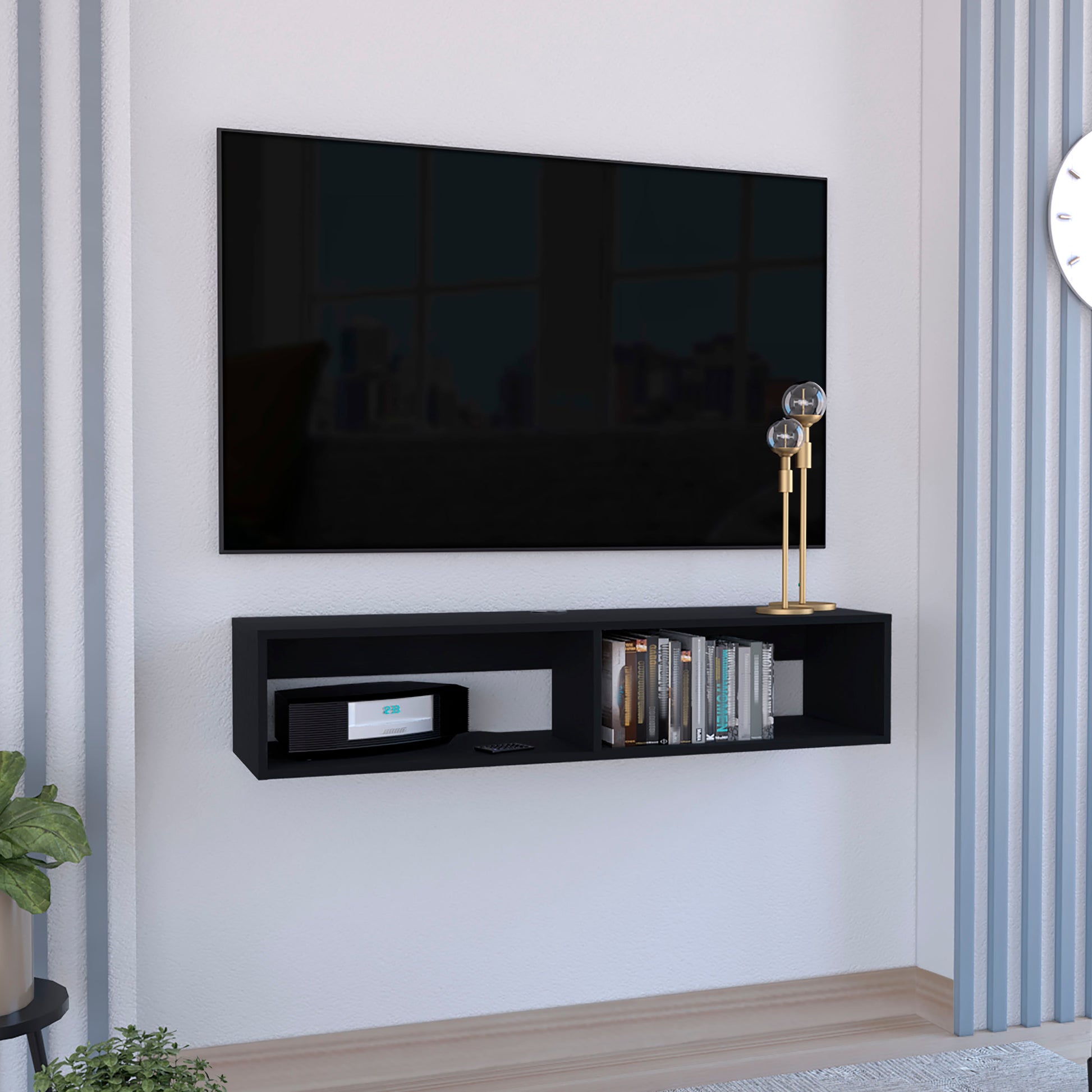 Sleek black floating TV stand holding media console and books enhancing living room
