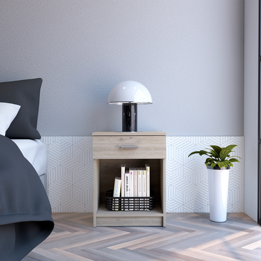 Light oak wood nightstand with one drawer and open shelf holding books and basket