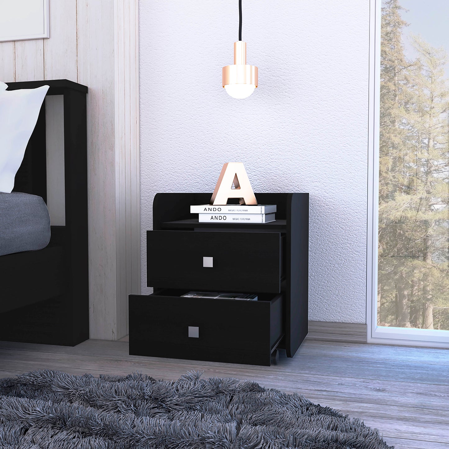 Modern black twodrawer nightstand with metal pulls placed beside a bed