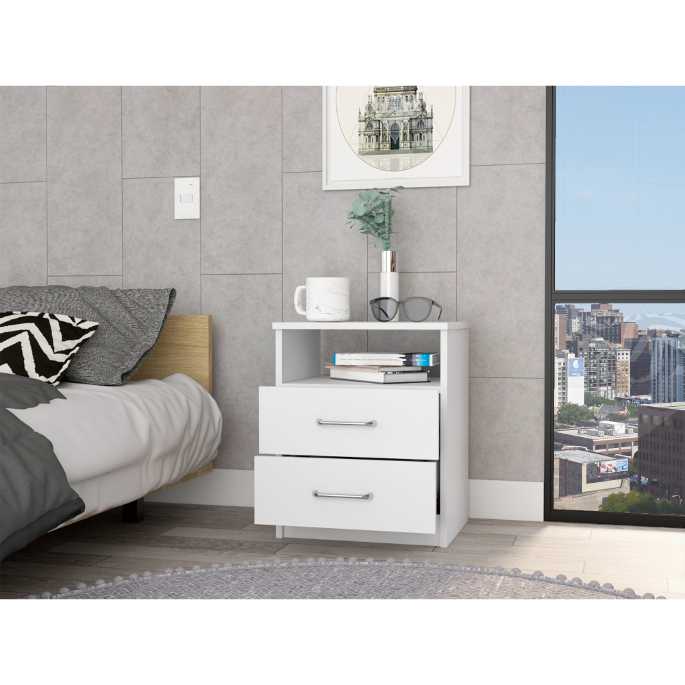 White twodrawer nightstand with silver handles beside a bed