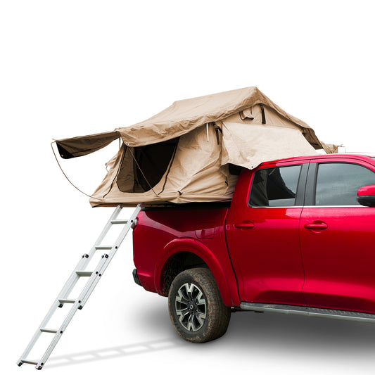 Tan rooftop tent unfolded on a red pickup truck with silver ladder extended