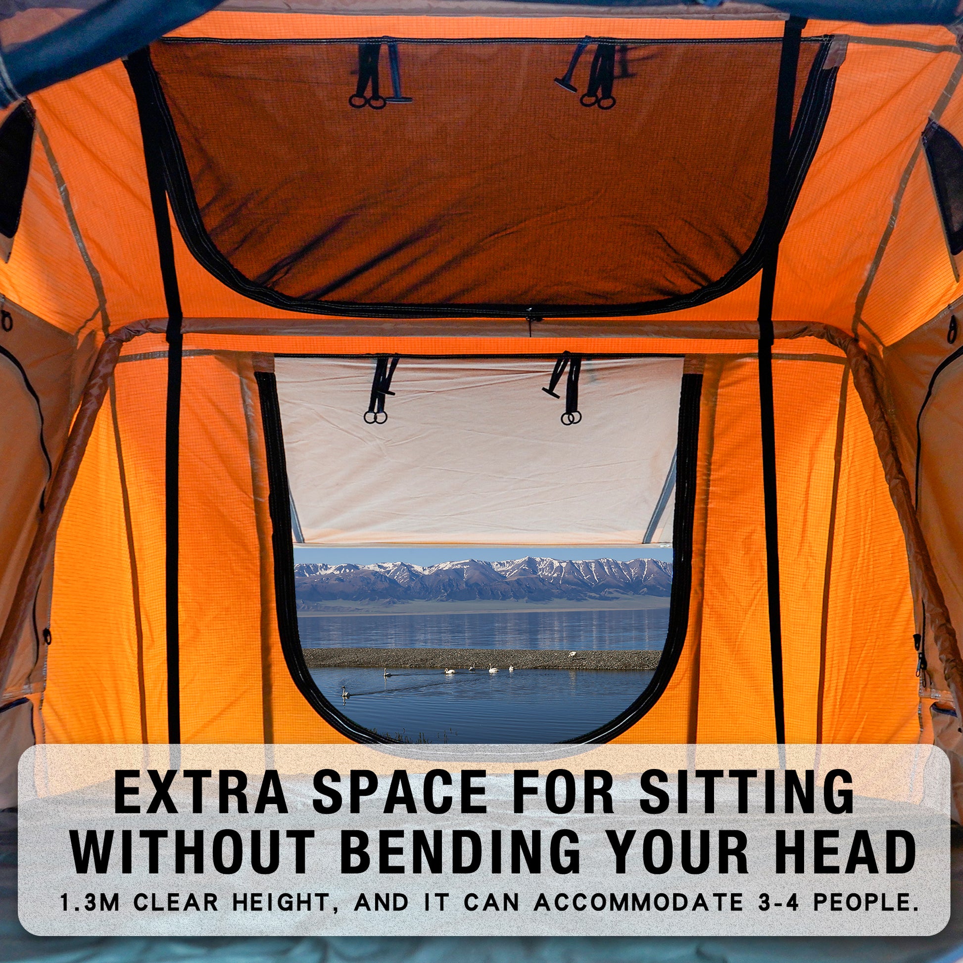 Orange rooftop tent interior with mesh window showing mountain lake view