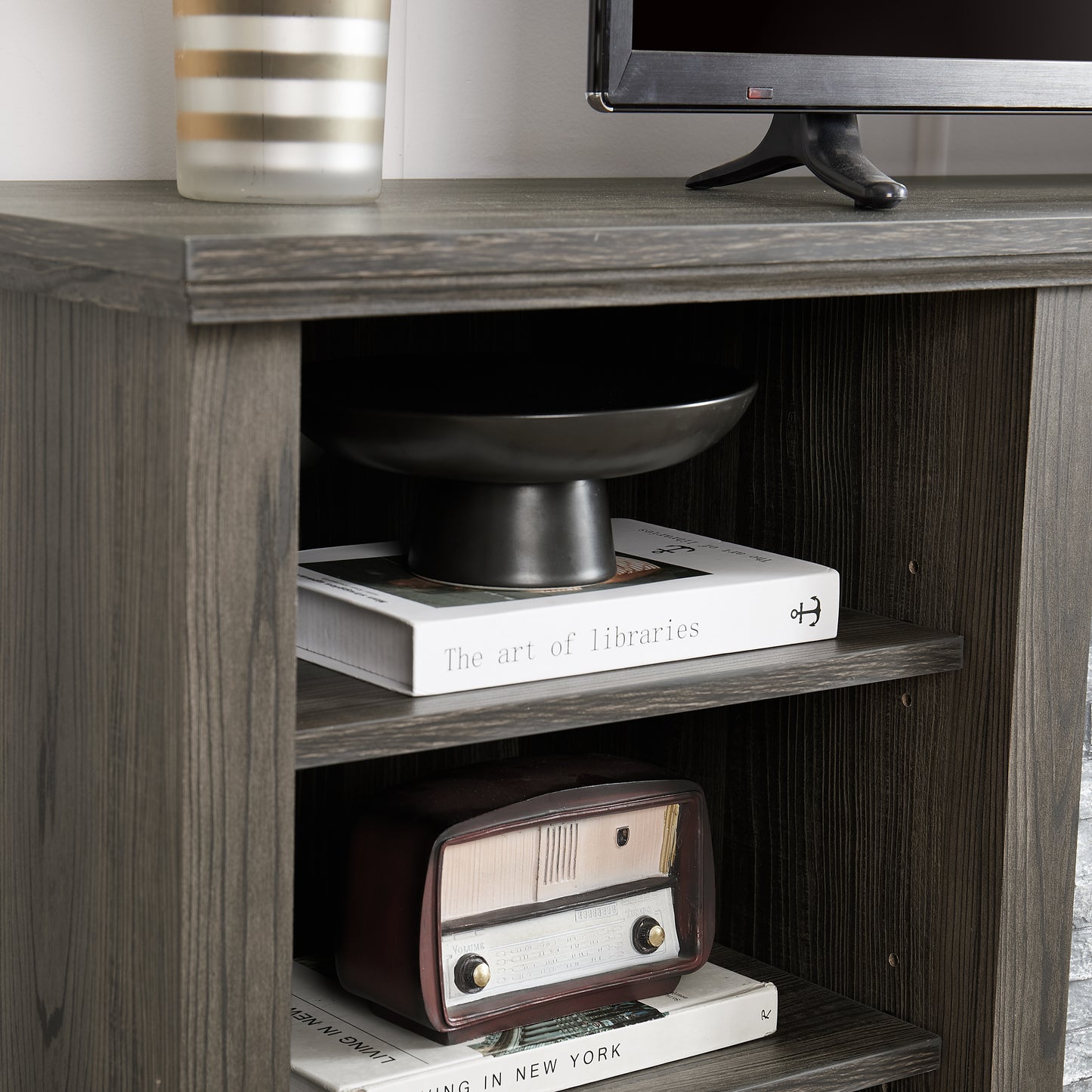 Dark wood entertainment center shelf with decorative bowl