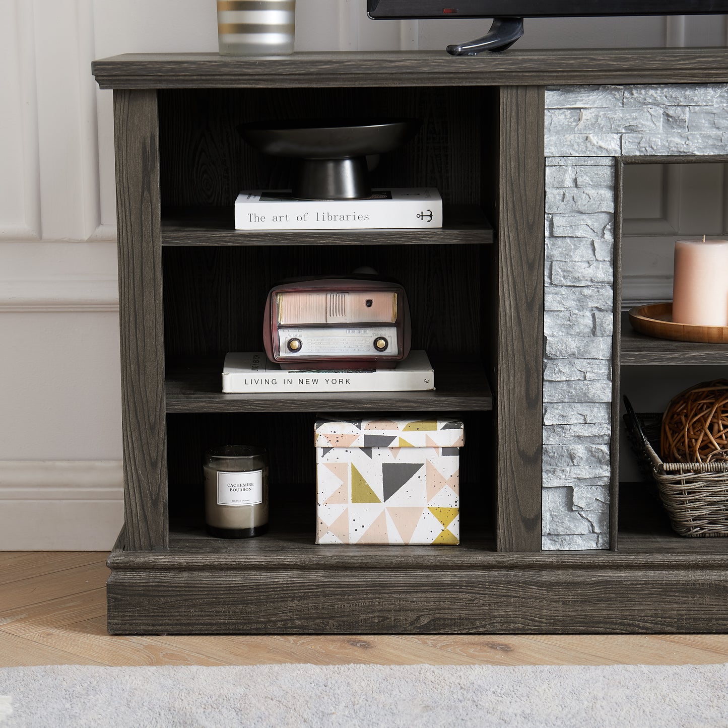 Dark wood media console with stone facade and storage shelves